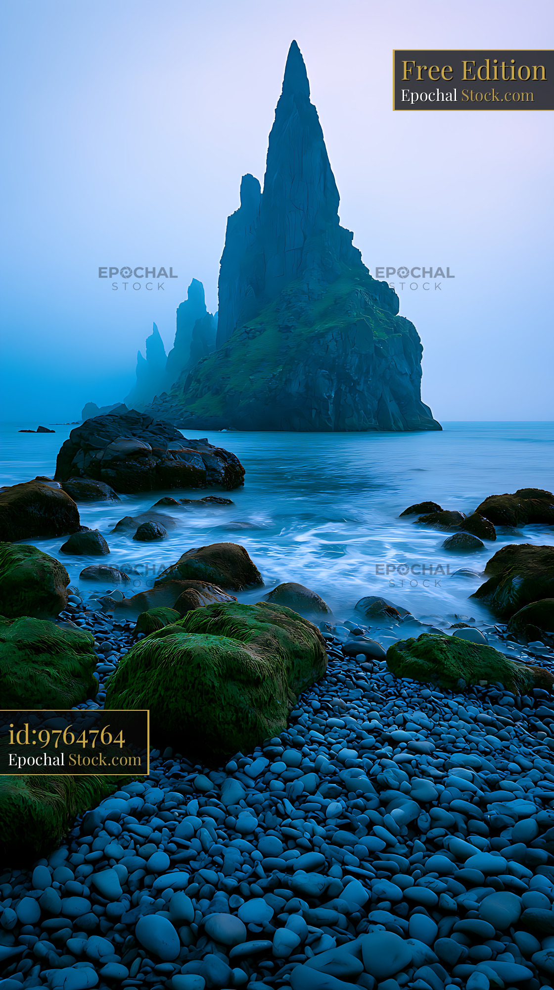 Majestic volcanic stack sea rising from a misty ocean at dawn - stock photo