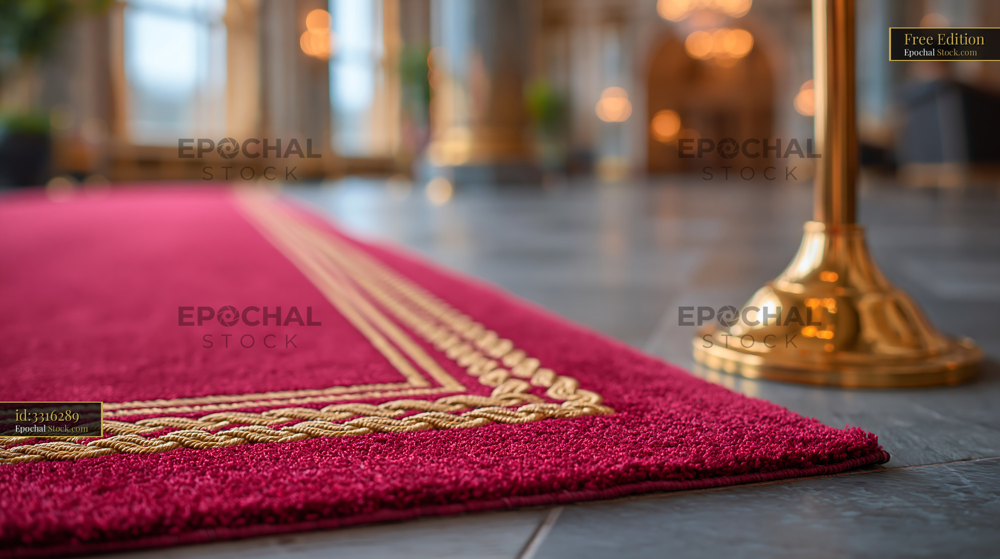 Close up of a red carpet with gold trim in a luxury hotel lobby - stock photo