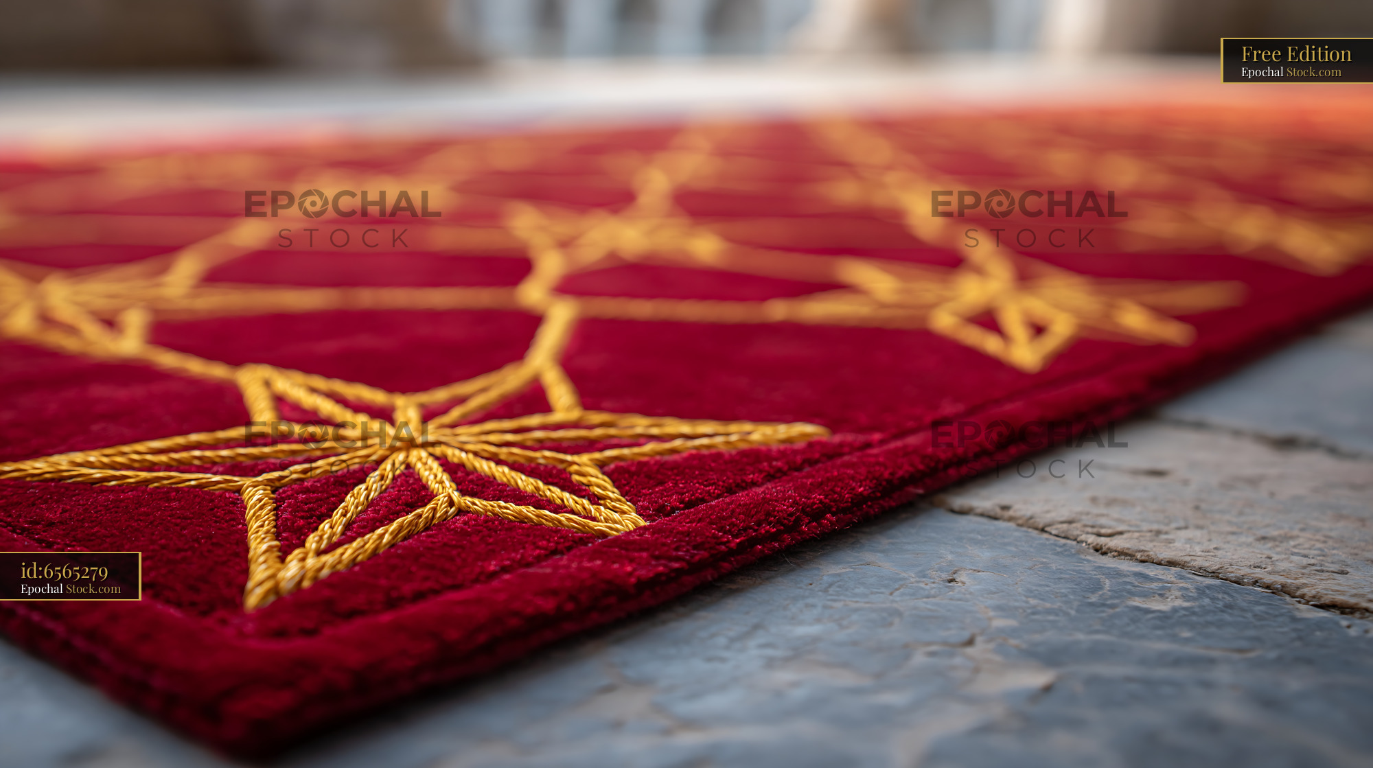 Red carpet with golden star pattern on stone floor at gala event - stock photo