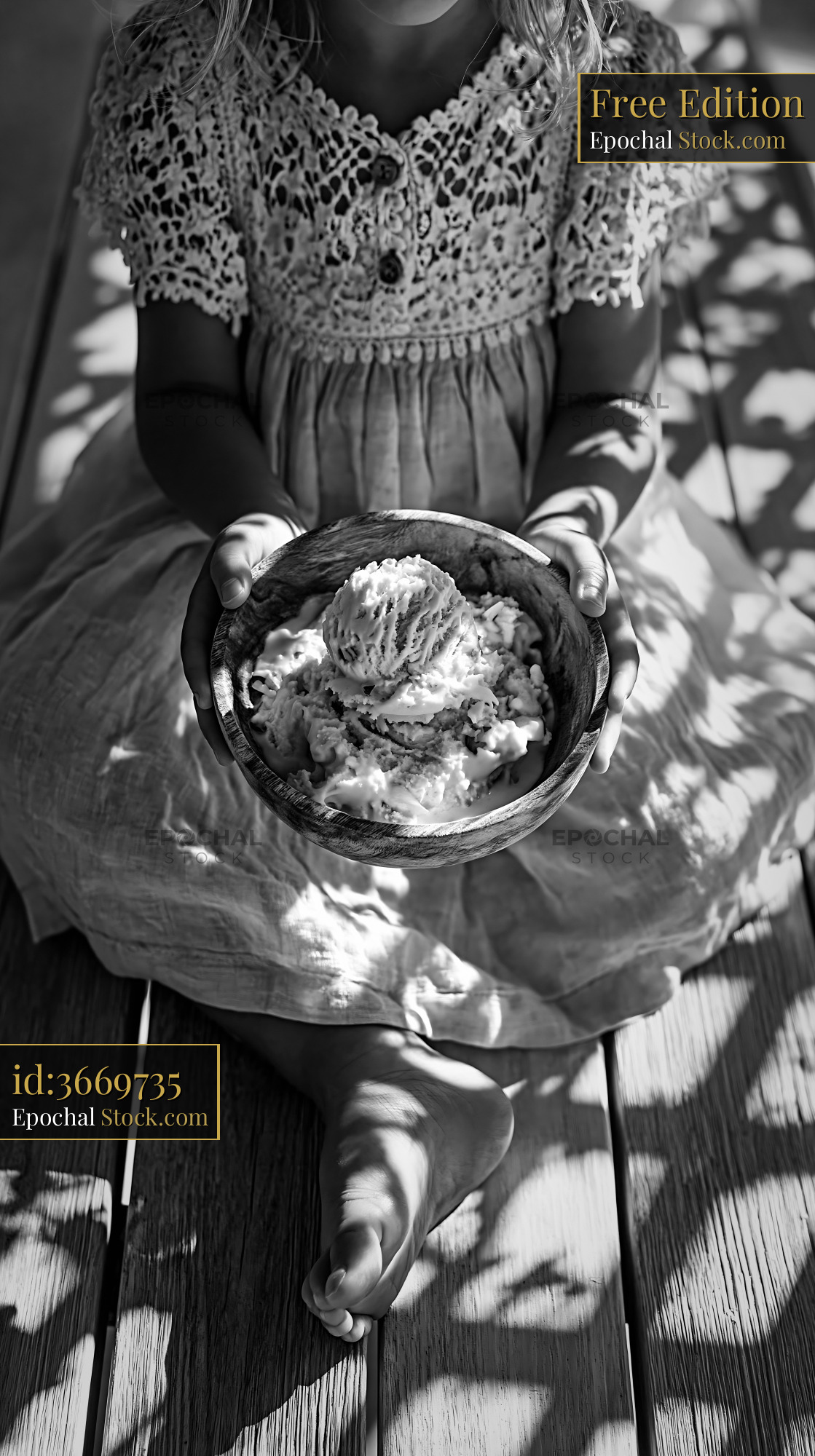 Young girl holding a bowl of almond paste ice cream on a sunny deck - stock photo