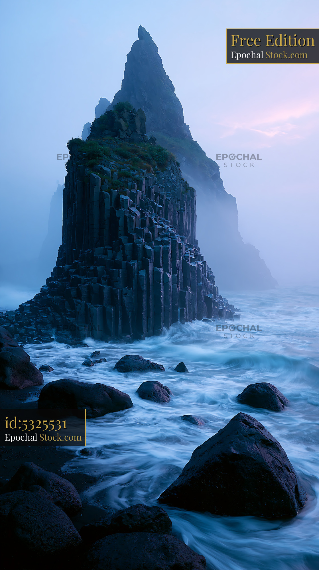 Basalt columns at Reynisfjara beach in the mist at dawn - stock photo