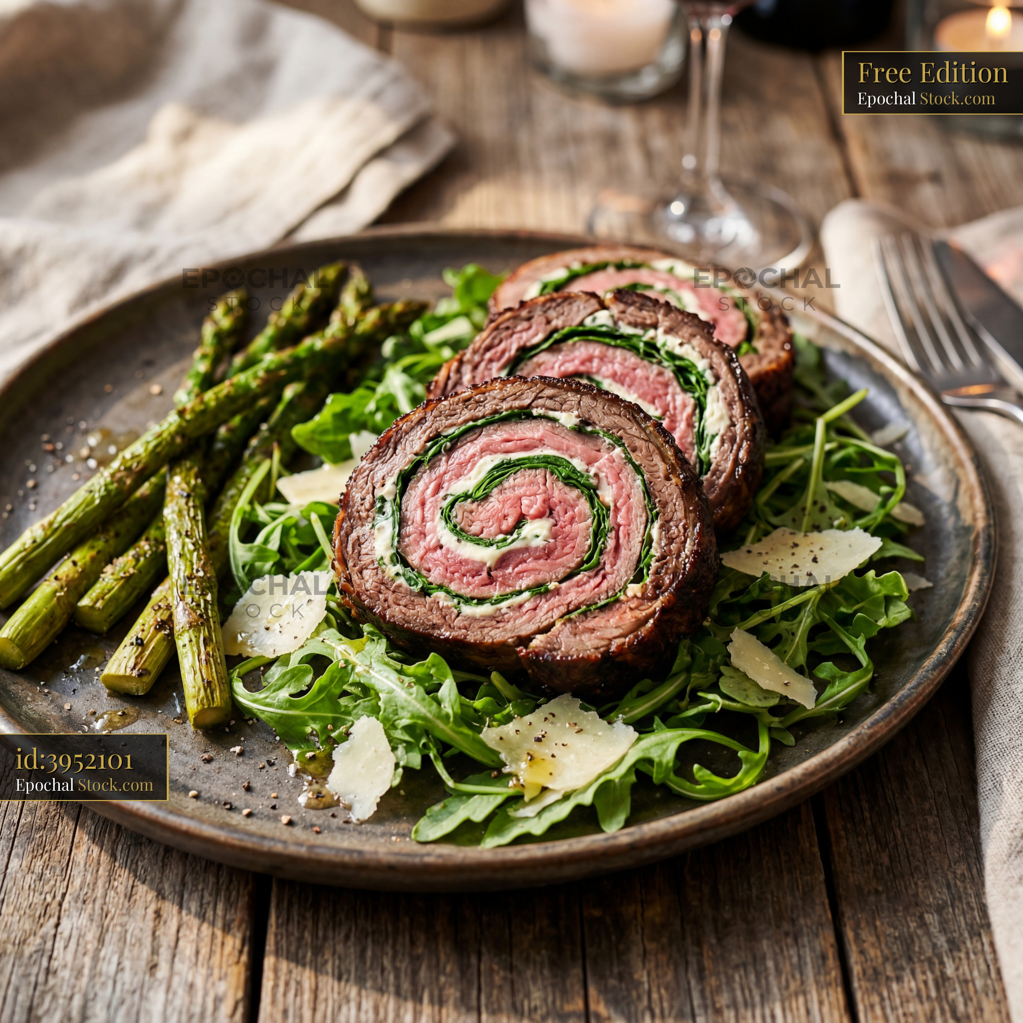 Sliced Beef Roulade with Asparagus on Arugula - stock photo