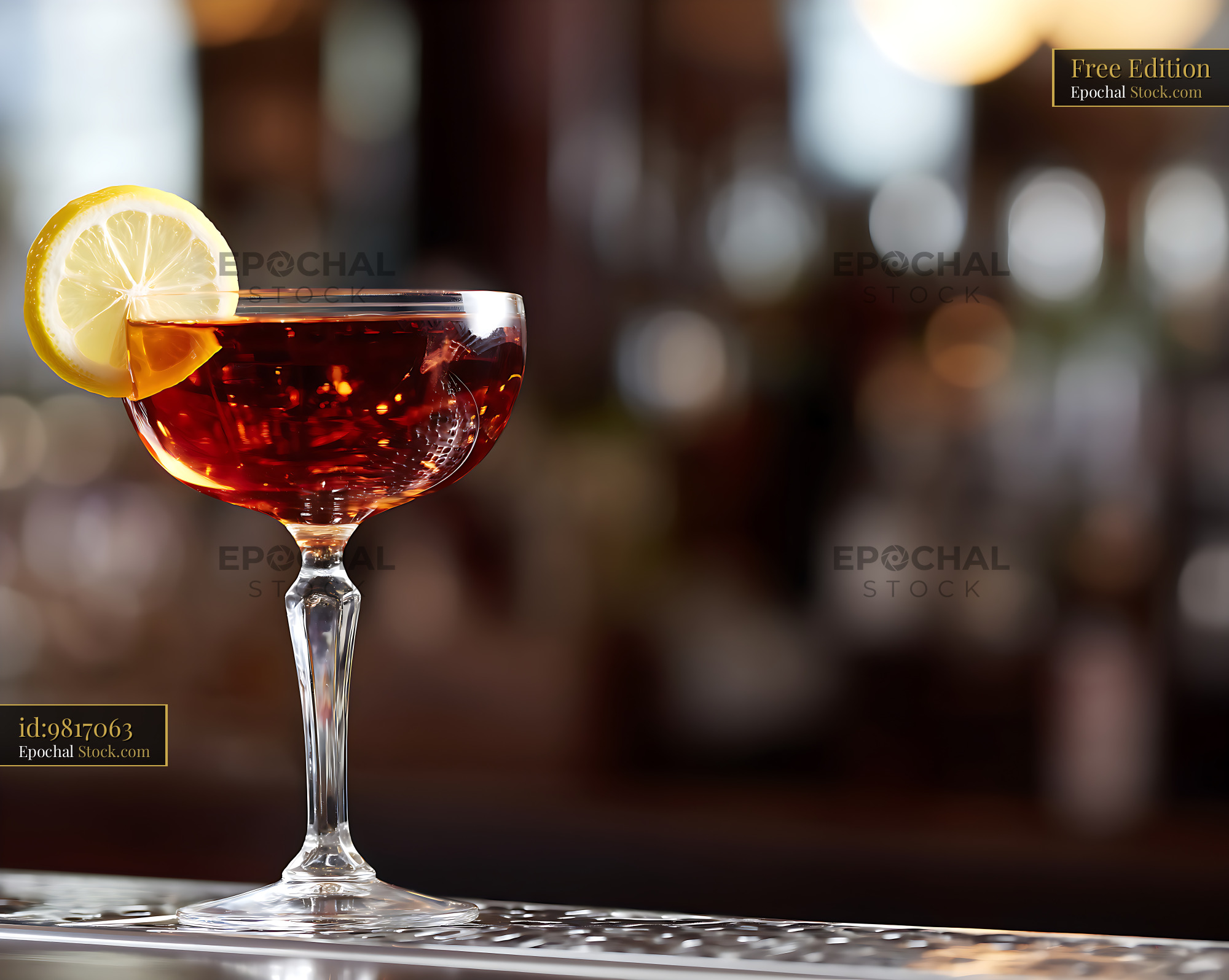 Elegant Red Cocktail with Lemon Garnish - stock photo