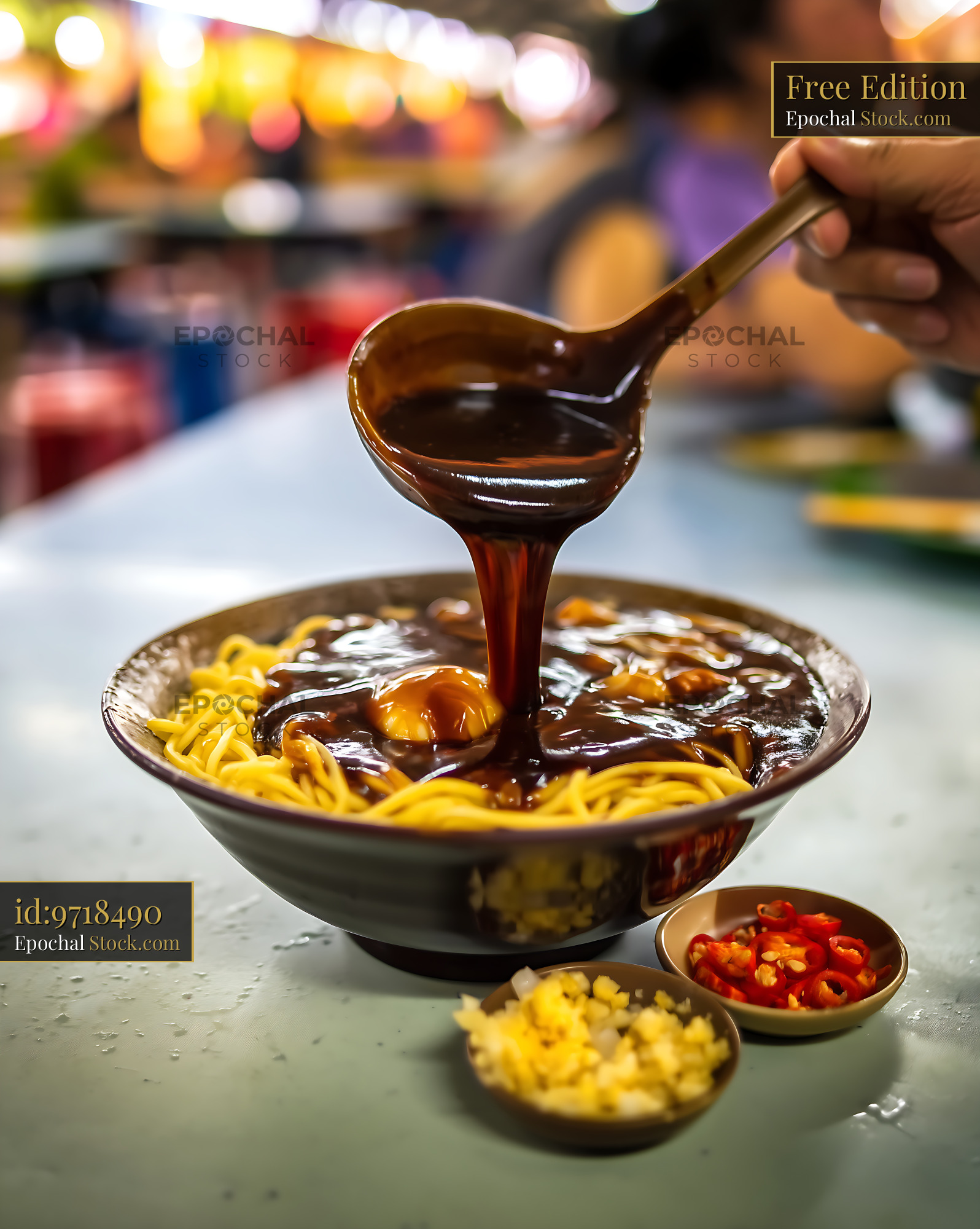 Lor Mee Soup Being Poured into a Bowl with Condiments - stock photo