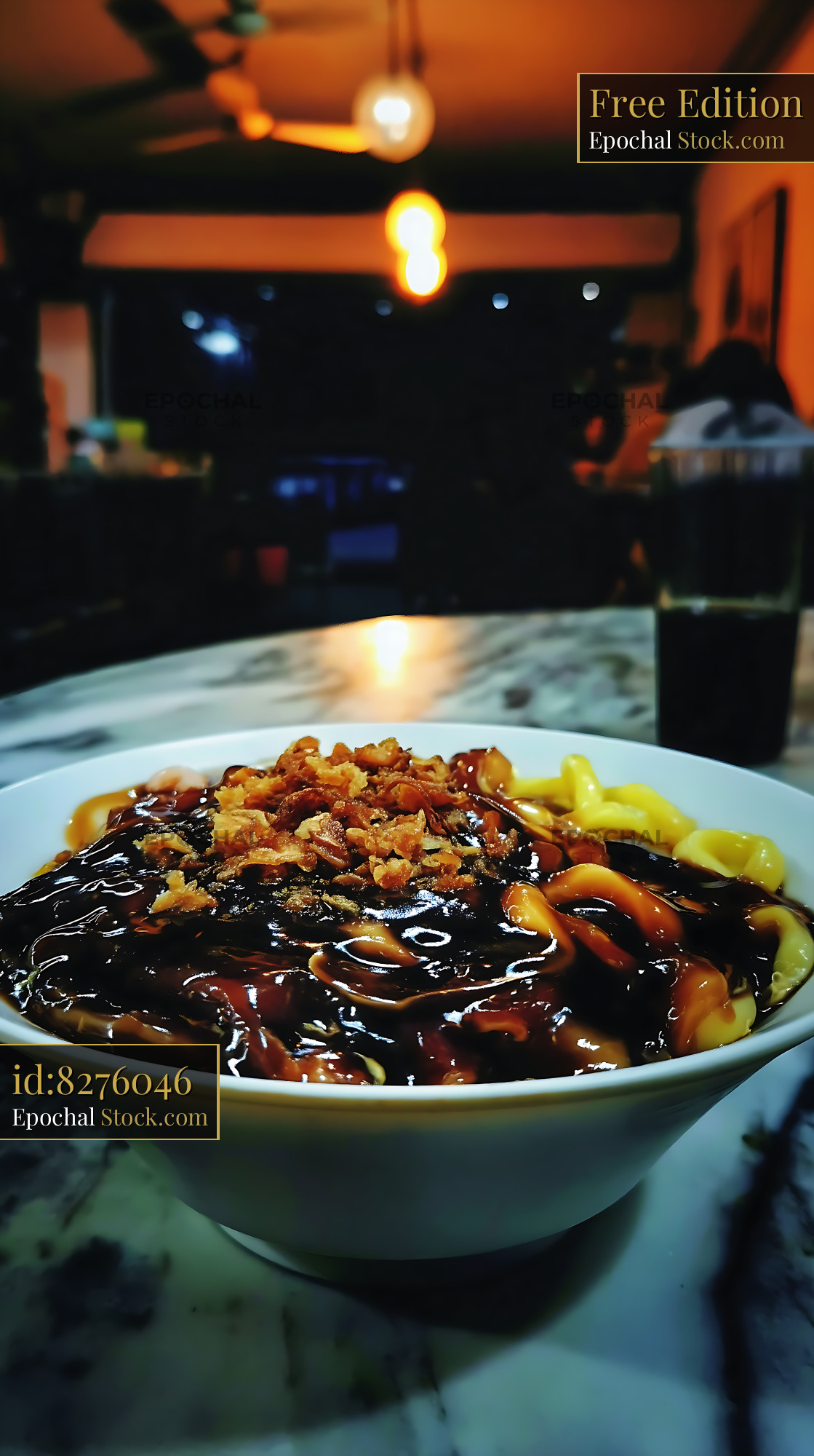 Lor Mee Soup Bowl with Crispy Toppings in Warm Restaurant - stock photo