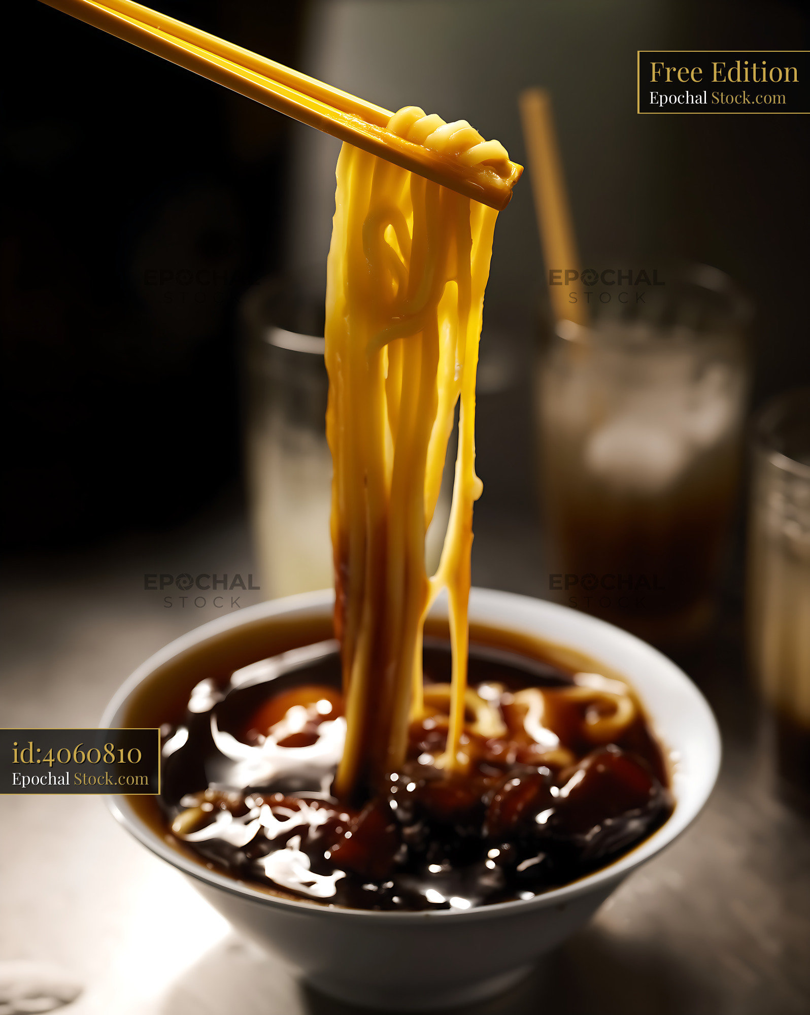 Golden Noodles Lifted from Rich Lor Mee Soup with Chopsticks - stock photo