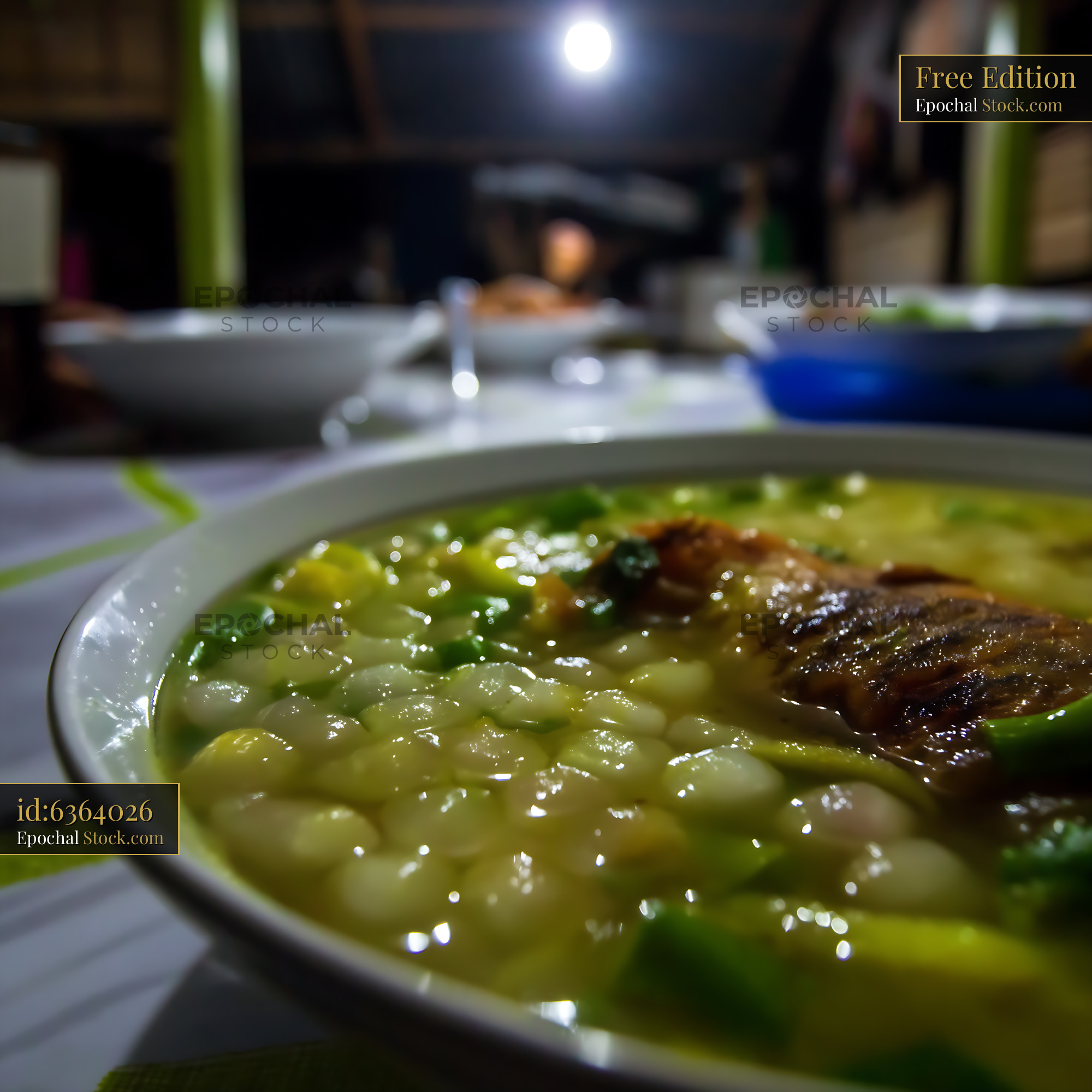 Hearty Lor Mee Soup with Fish in Dimly Lit Setting - stock photo