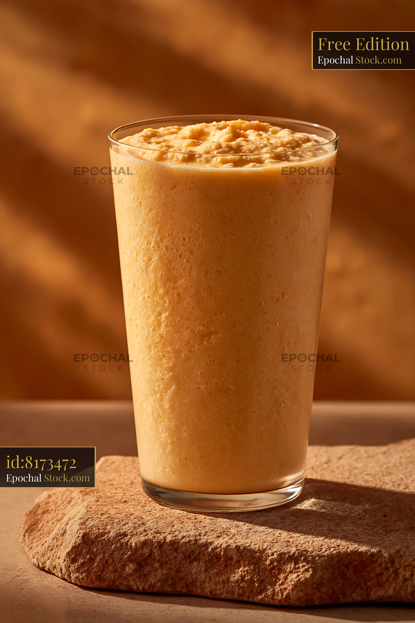 Cloudberry cream milkshake in a glass on a stone surface - stock photo