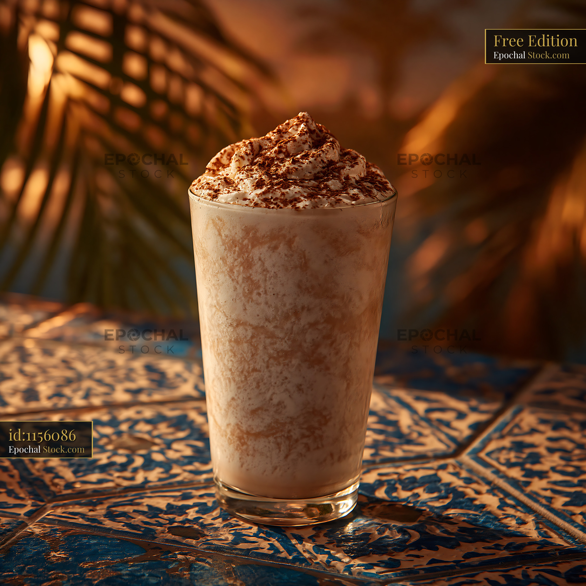 Pawpaw punch milkshake in a glass on an ornate tiled table - stock photo