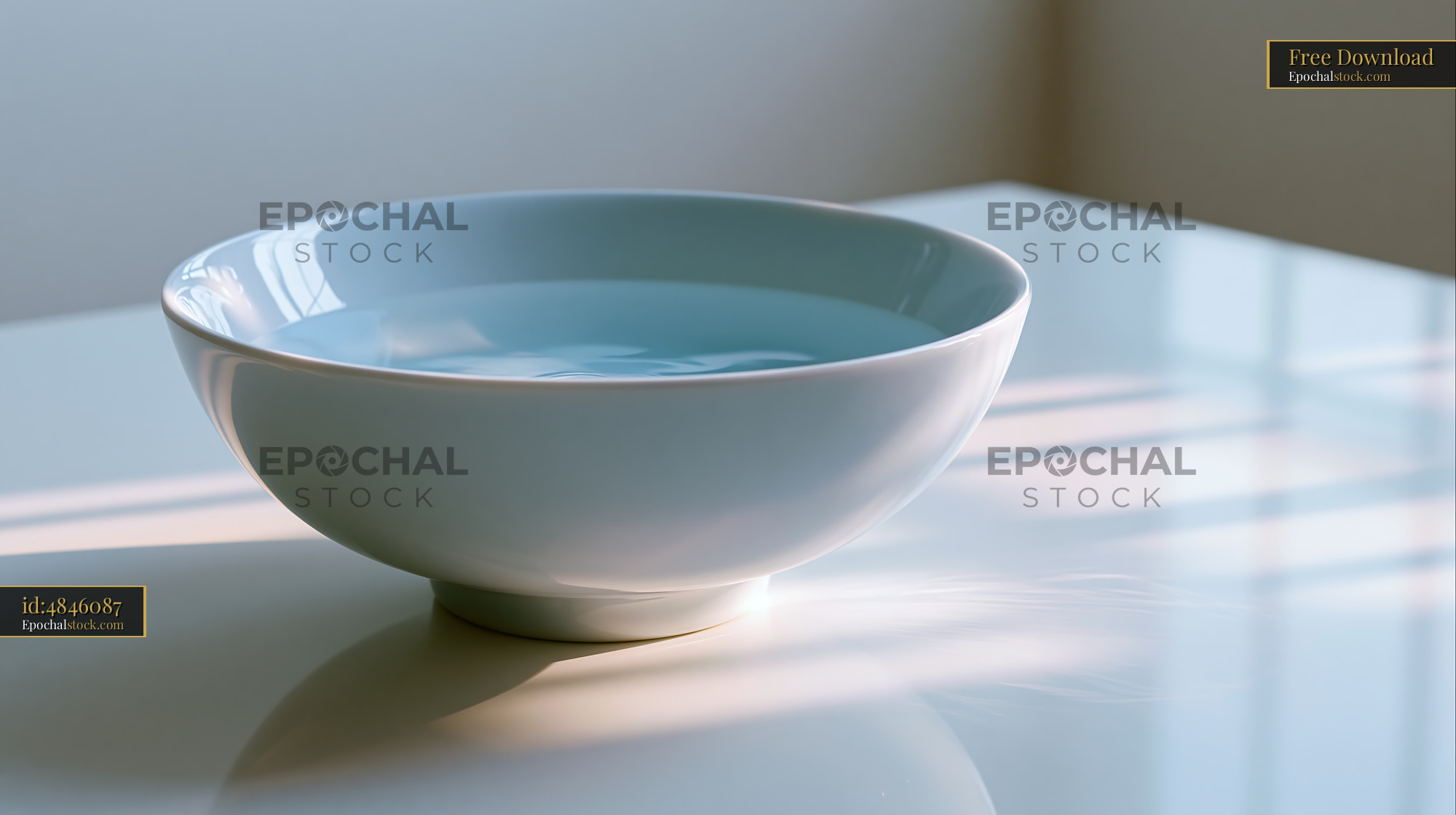 Watermarked full-resolution preview of Bowl filled with water on a white surface in soft light