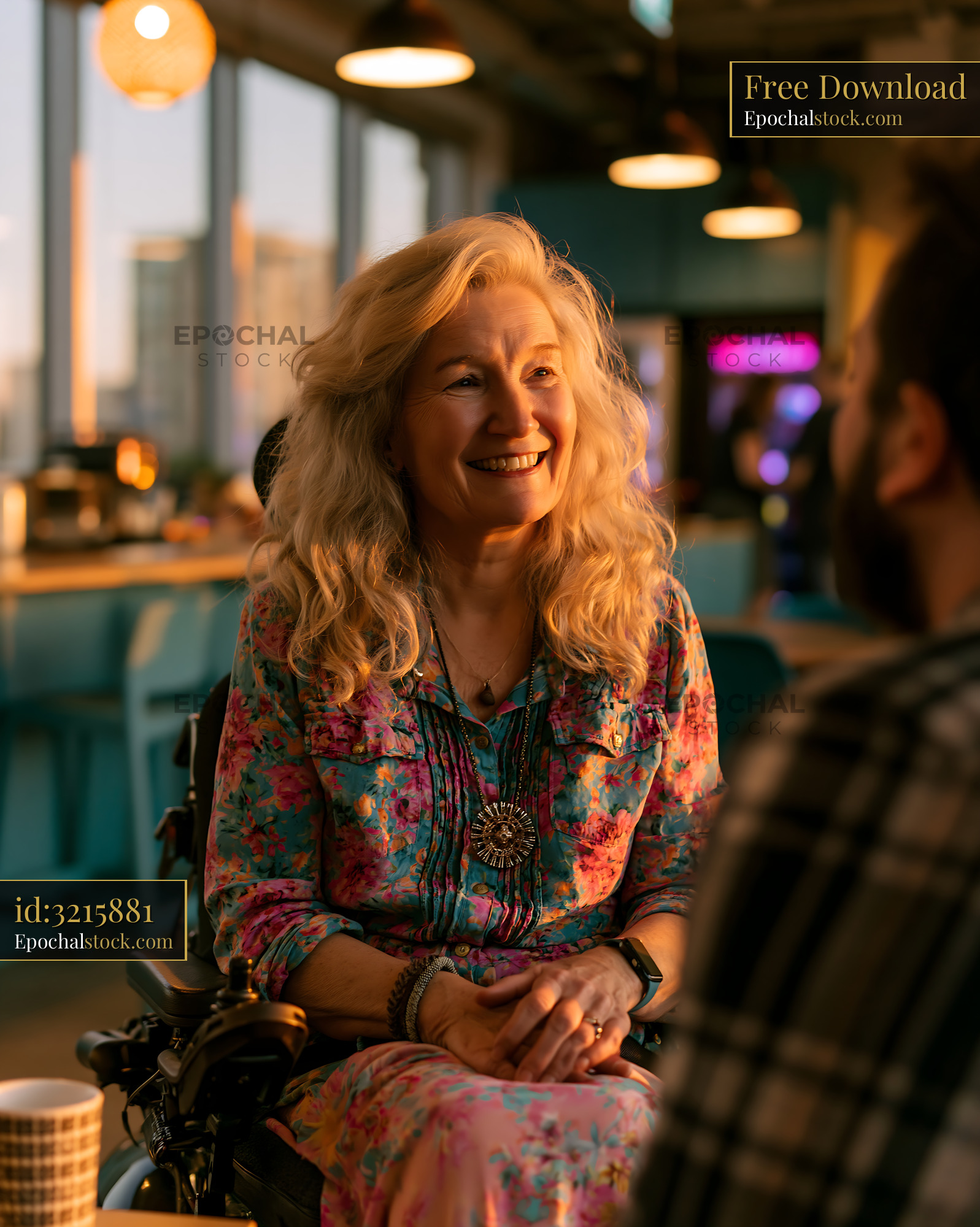 Watermarked full-resolution preview of Woman in wheelchair smiling during conversation in cafe