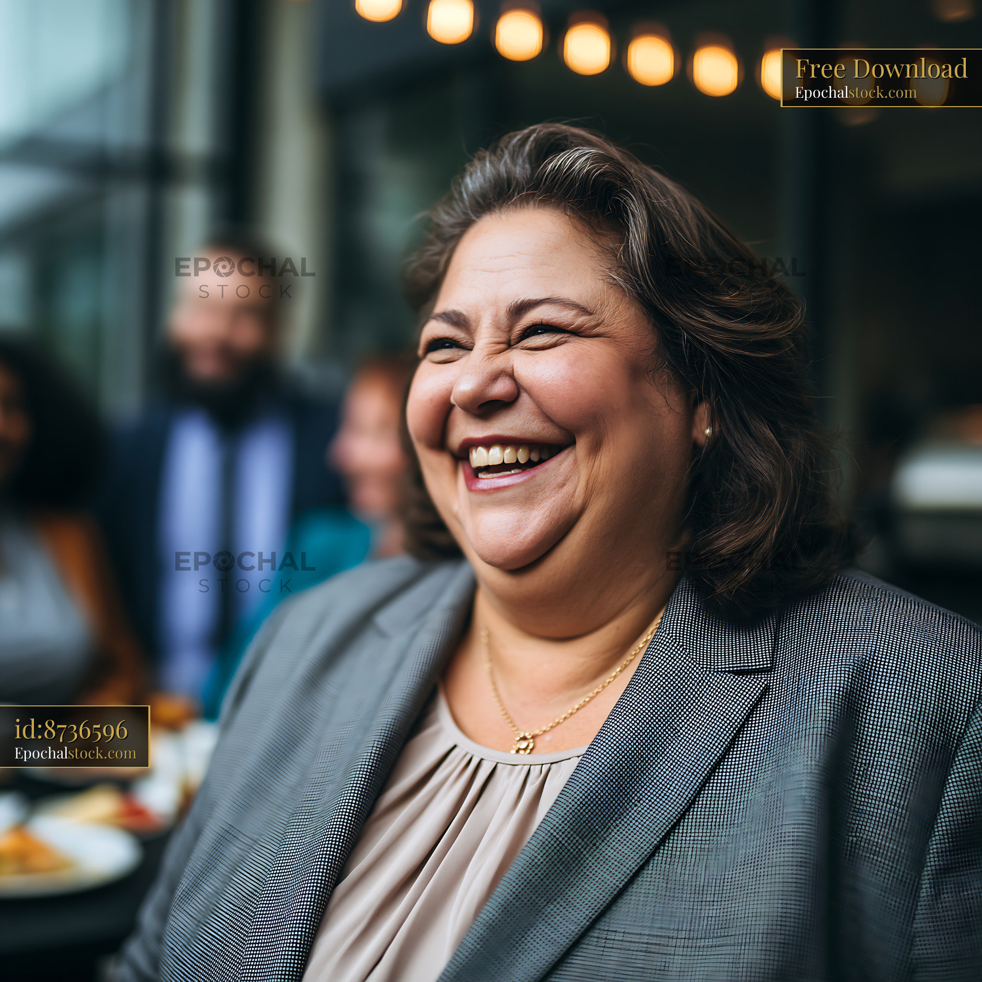 Watermarked full-resolution preview of Smiling woman in a gray suit at a social gathering