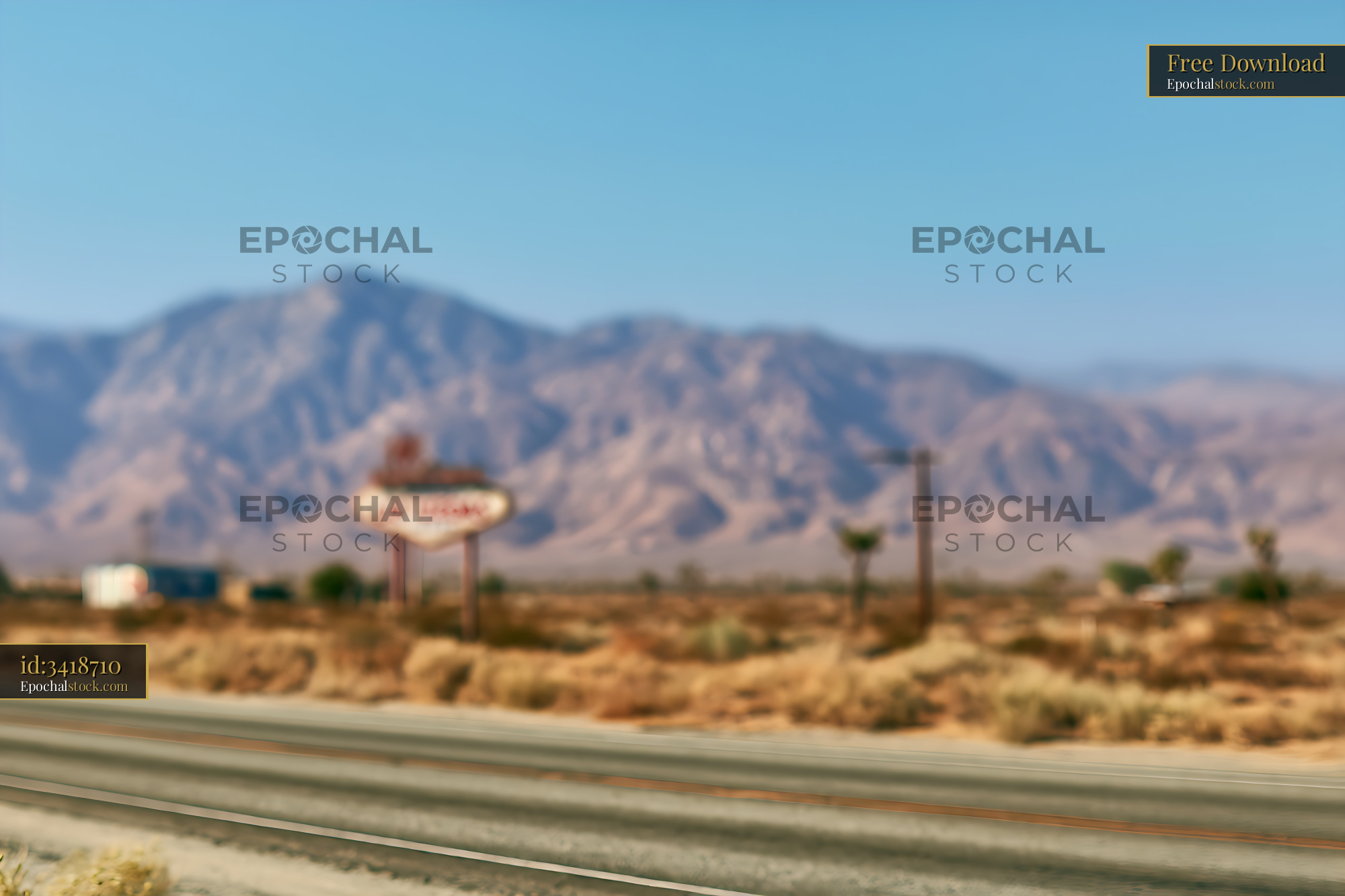 Watermarked full-resolution preview of Soft-focus desert road and rugged mountains