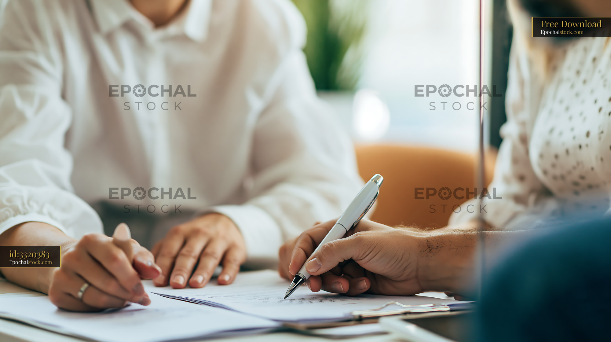 Watermarked full-resolution preview of Meeting at a table with documents and notepad in a bright office