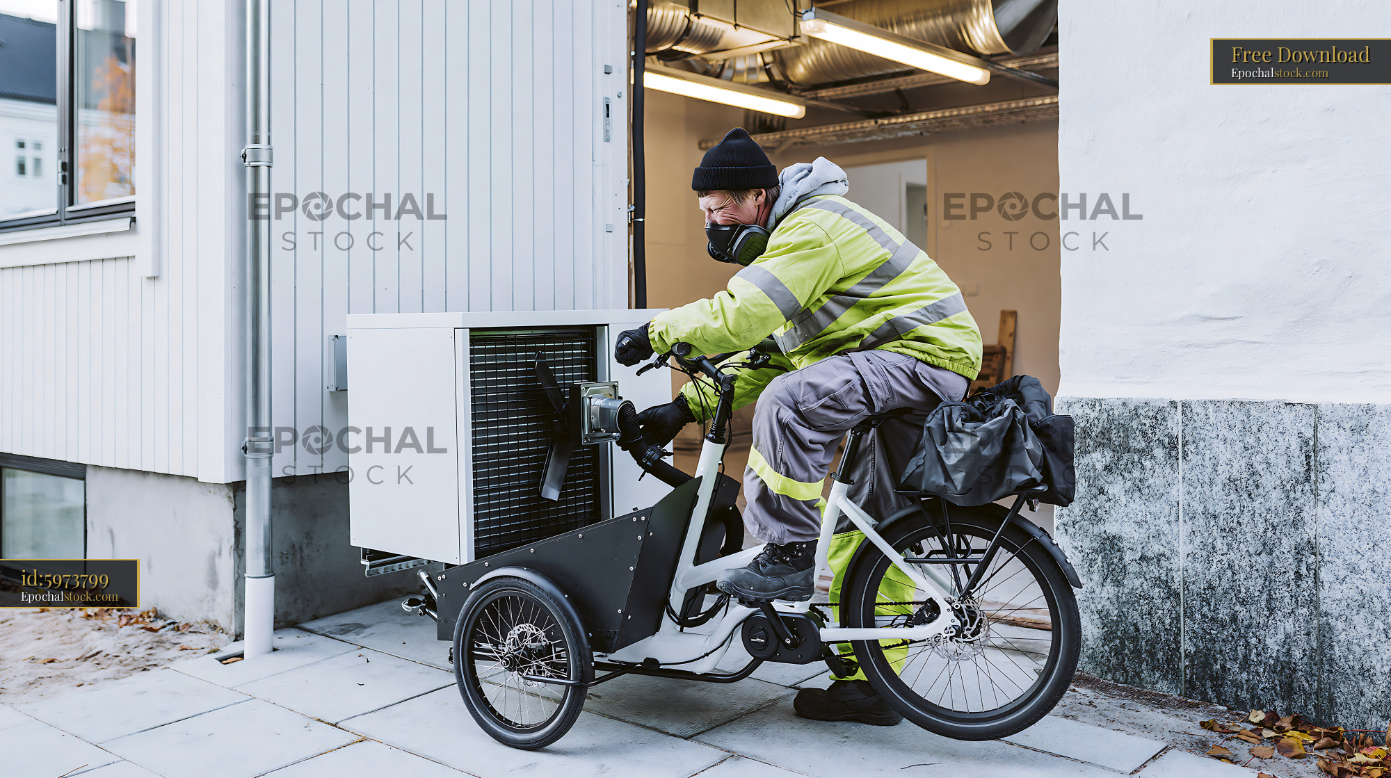 Watermarked full-resolution preview of Delivery person on cargo bike handling equipment near building