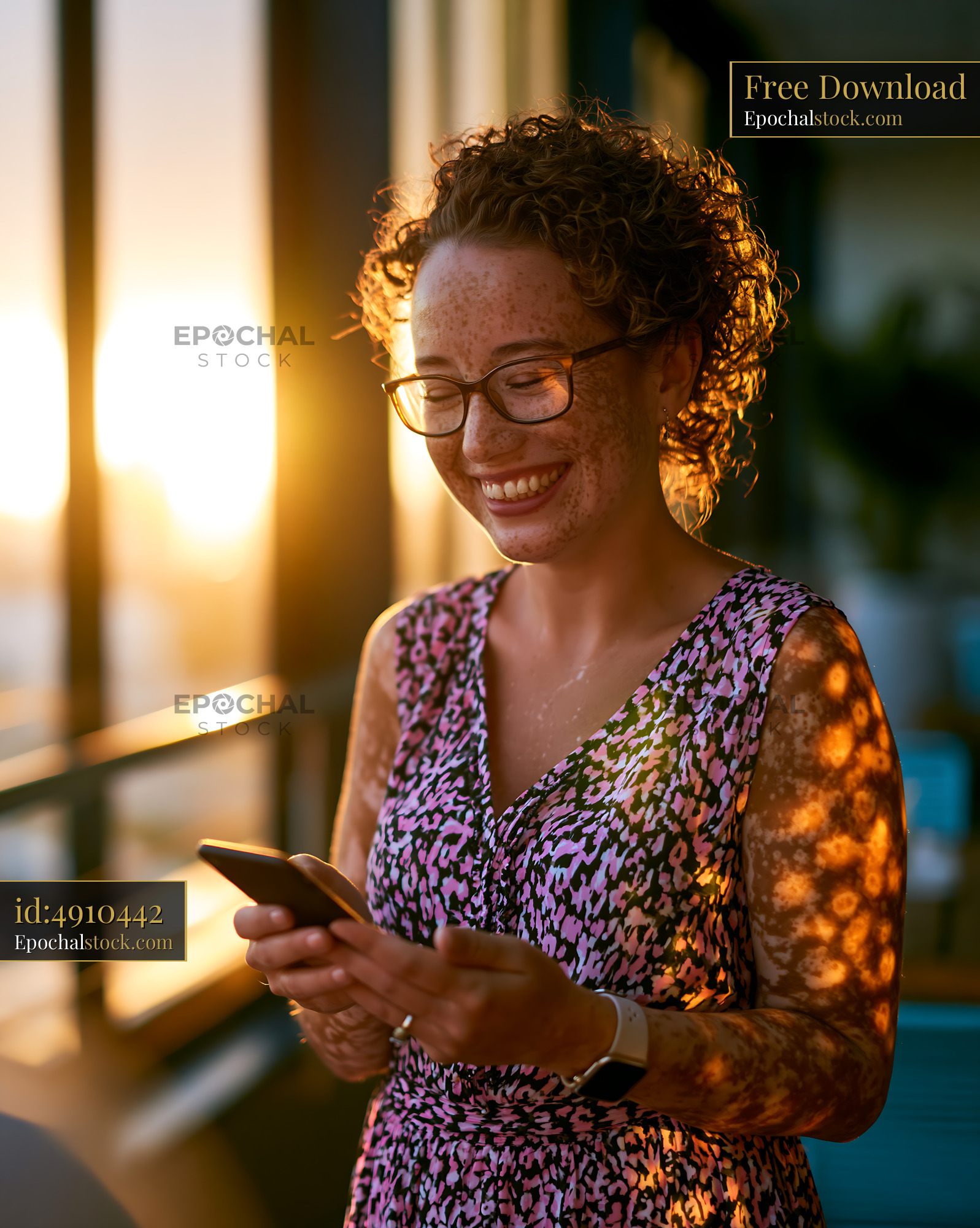 Watermarked full-resolution preview of Woman smiling while using smartphone during sunset