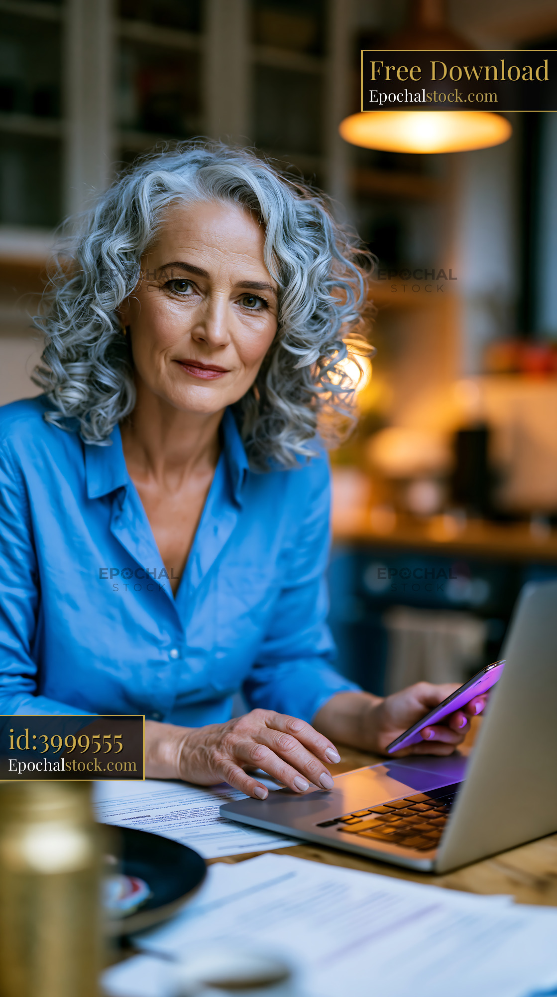 Watermarked full-resolution preview of Woman working on laptop in home office environment