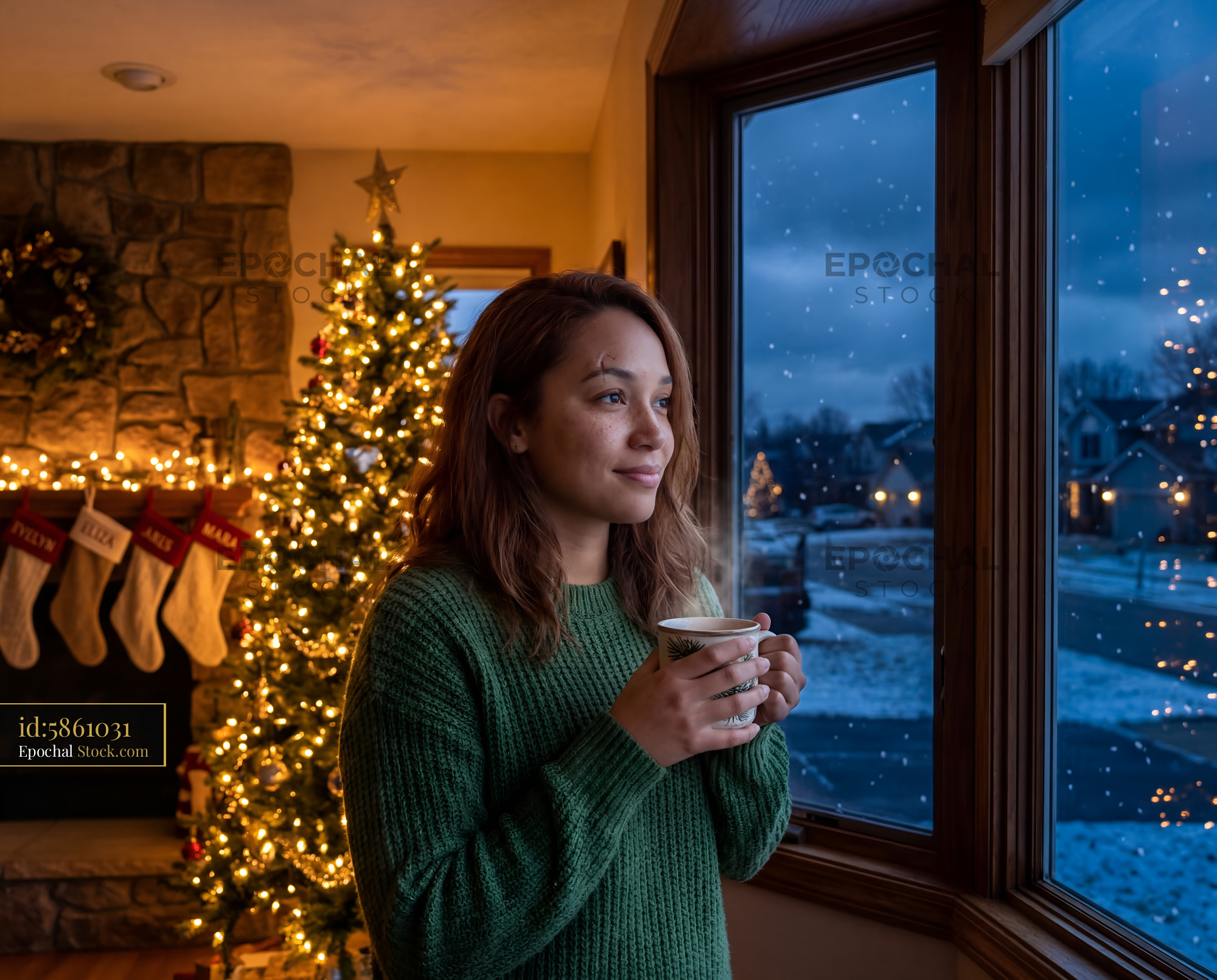 Woman enjoys a warm drink by the window during winter Premium Stock Photo