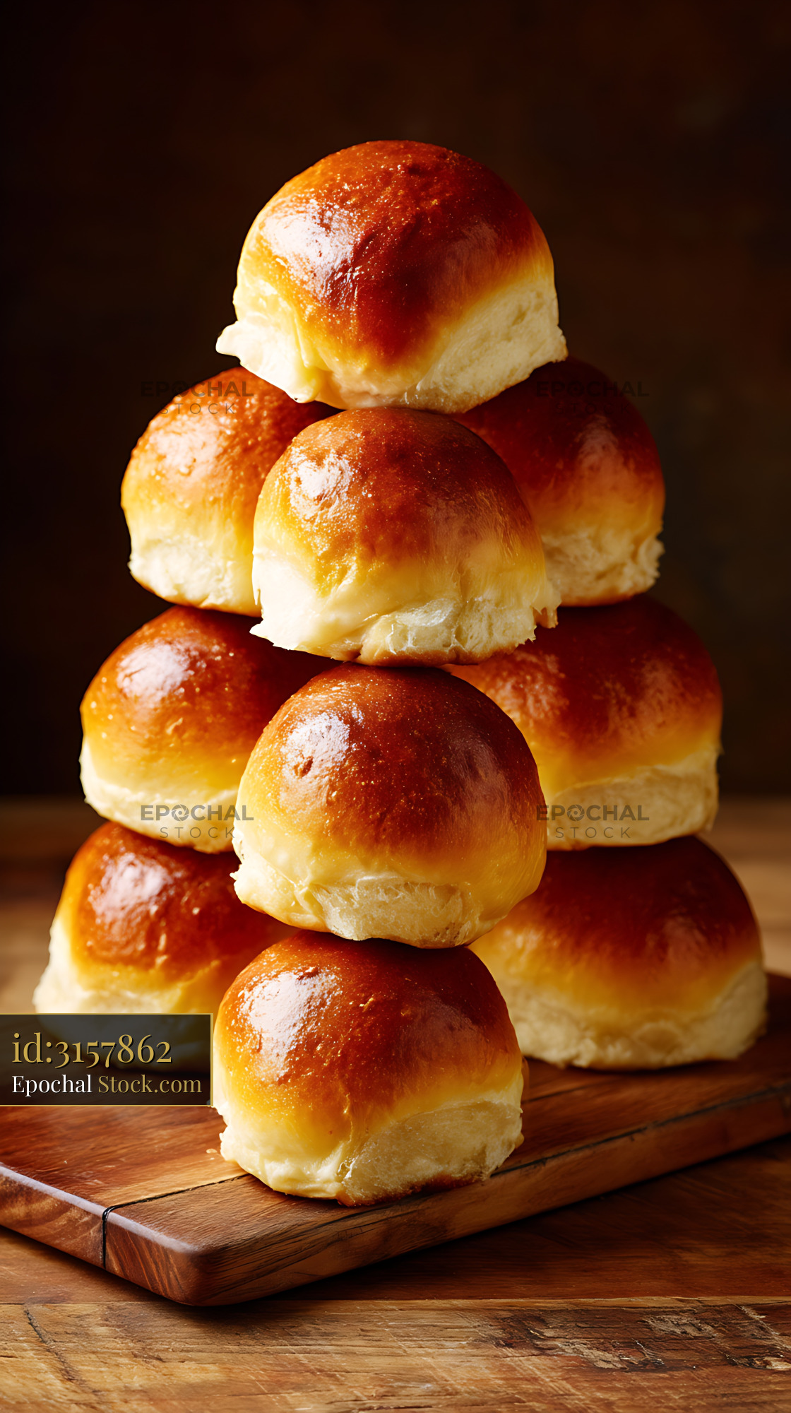Bierocks Golden Crust Rolls Pyramid Stacked on Wooden Serving Board - stock photo