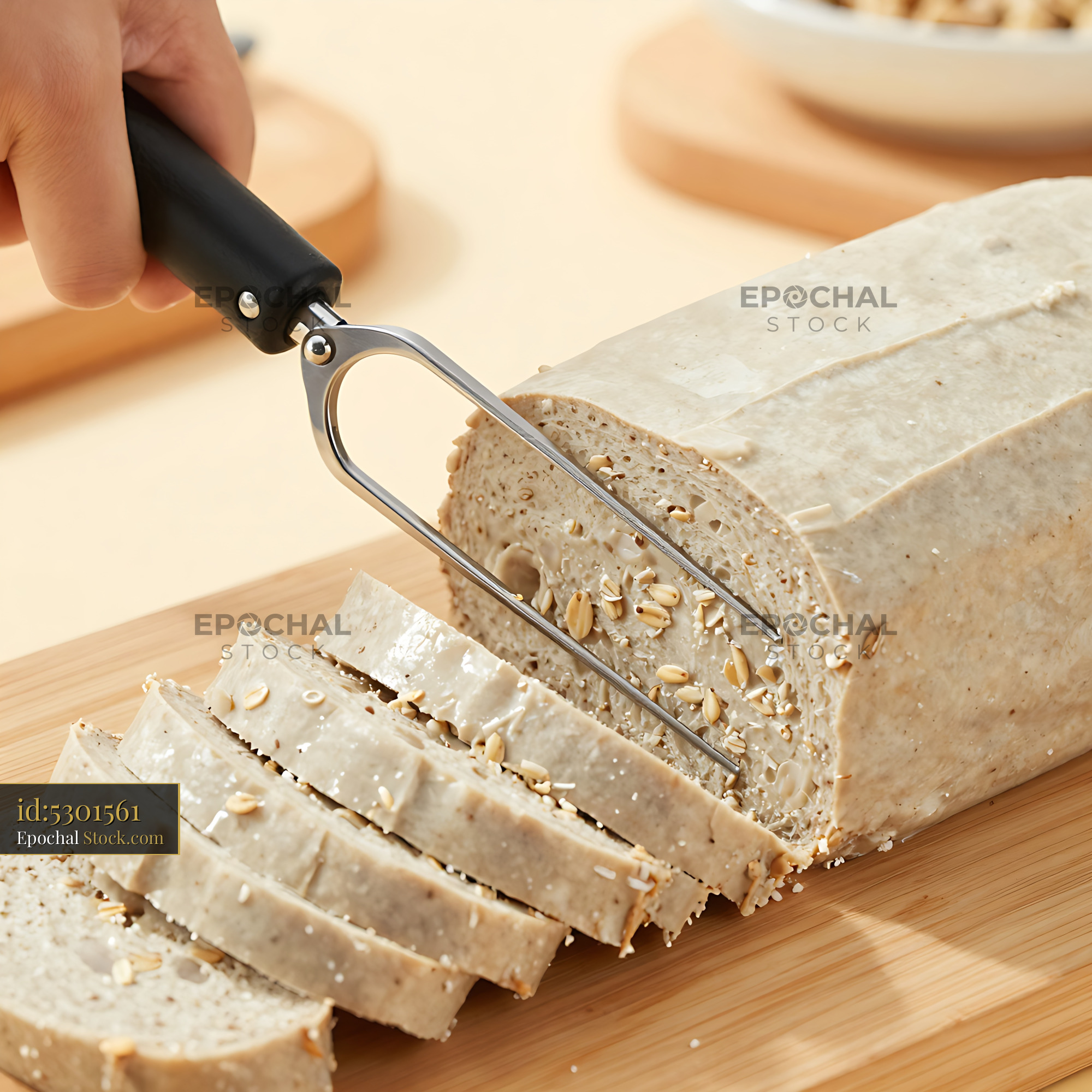 Whole Grain Bread Sliced with Wire Cutter - stock photo