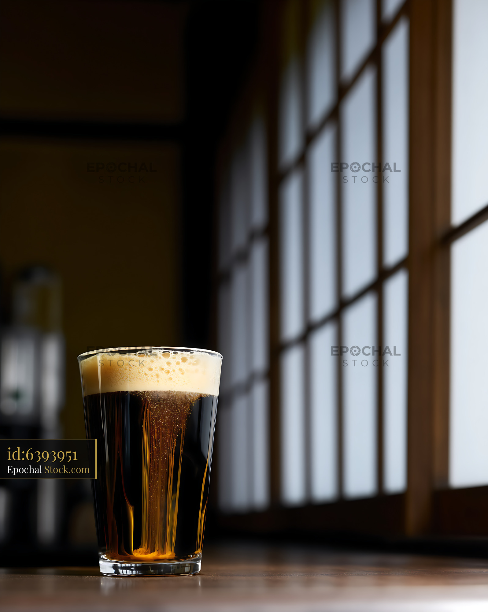 Dark Stout Beer with Creamy Head by Window - stock photo
