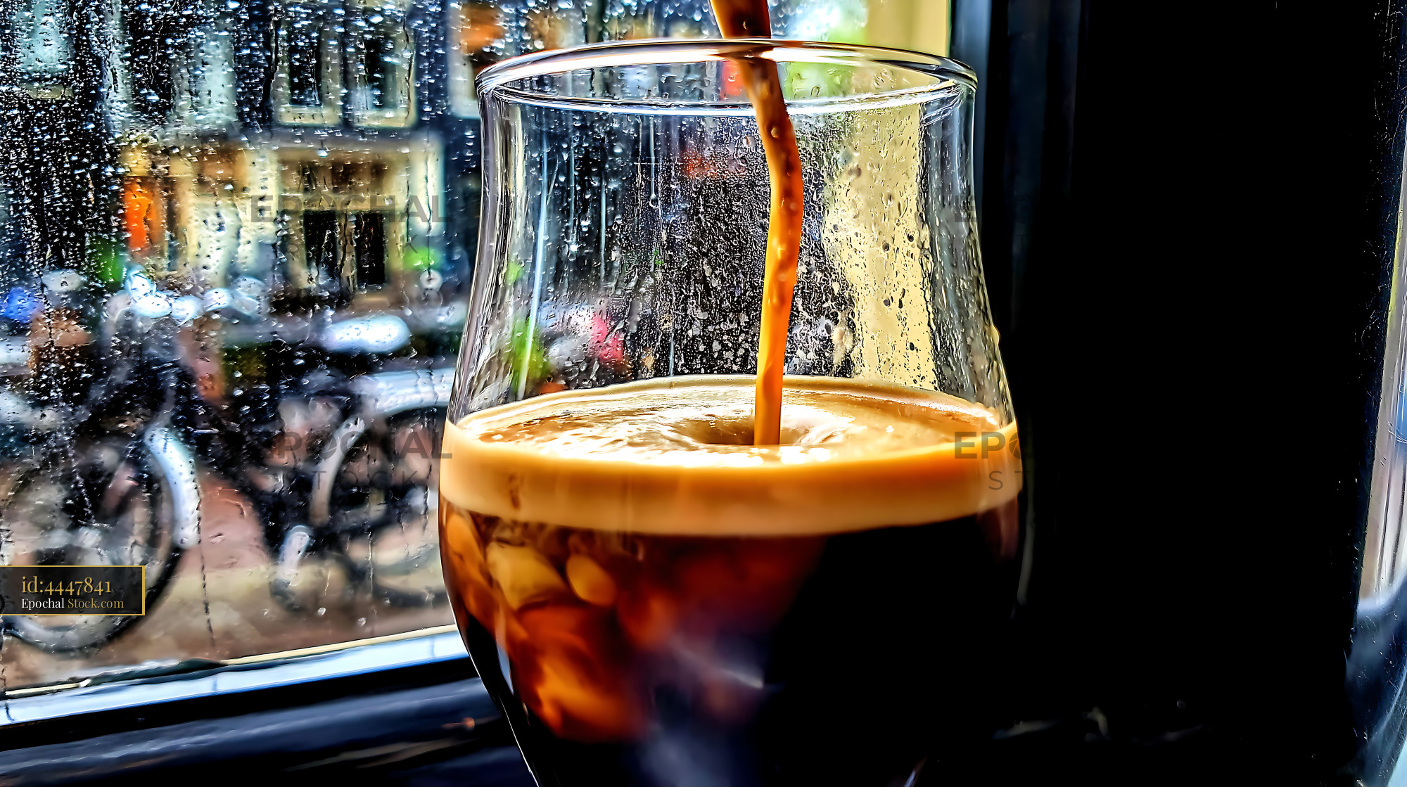 Nitro Caramel Coffee Pour by Rainy Window - stock photo