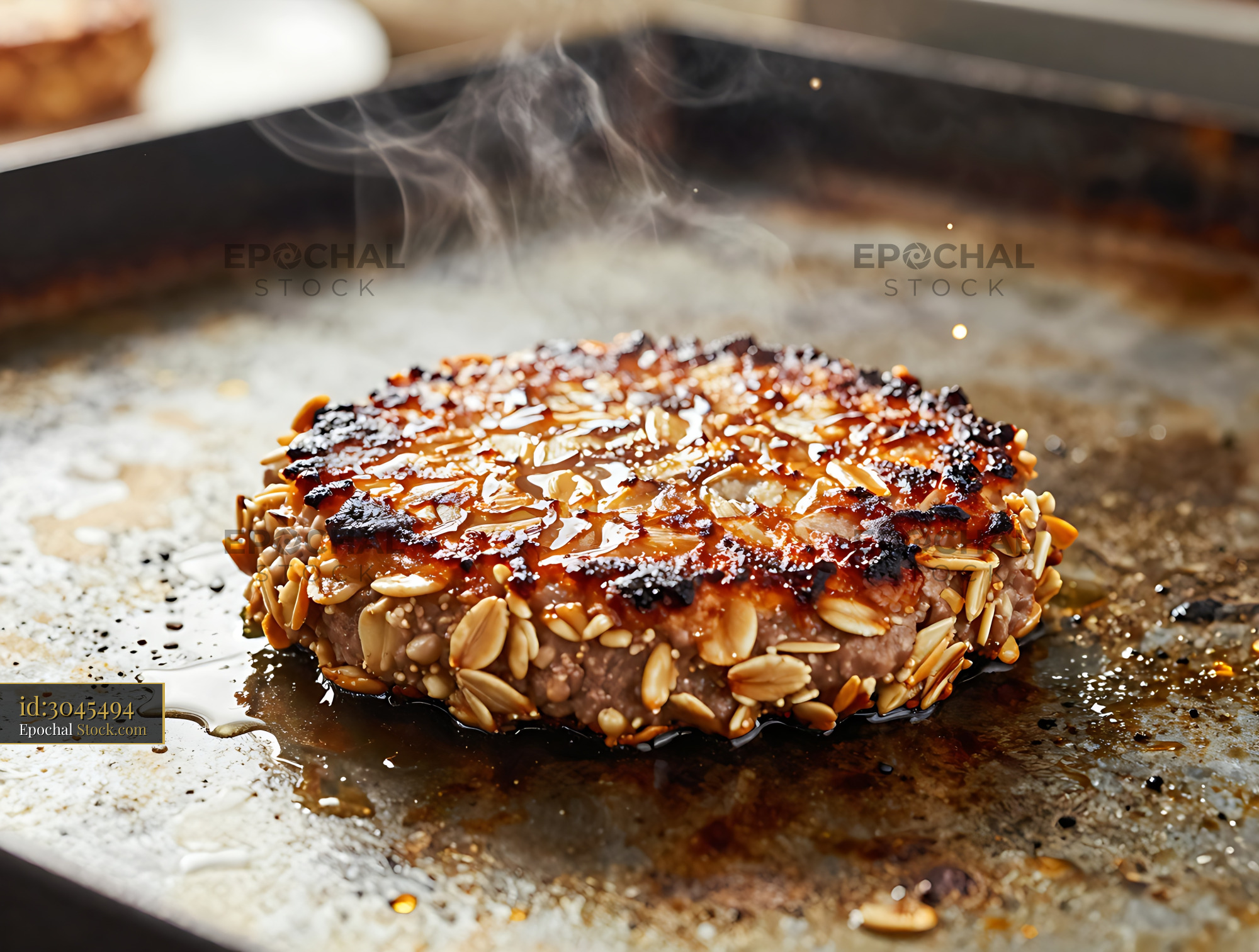 Almond-Crusted Burger Cooking on Griddle - stock photo