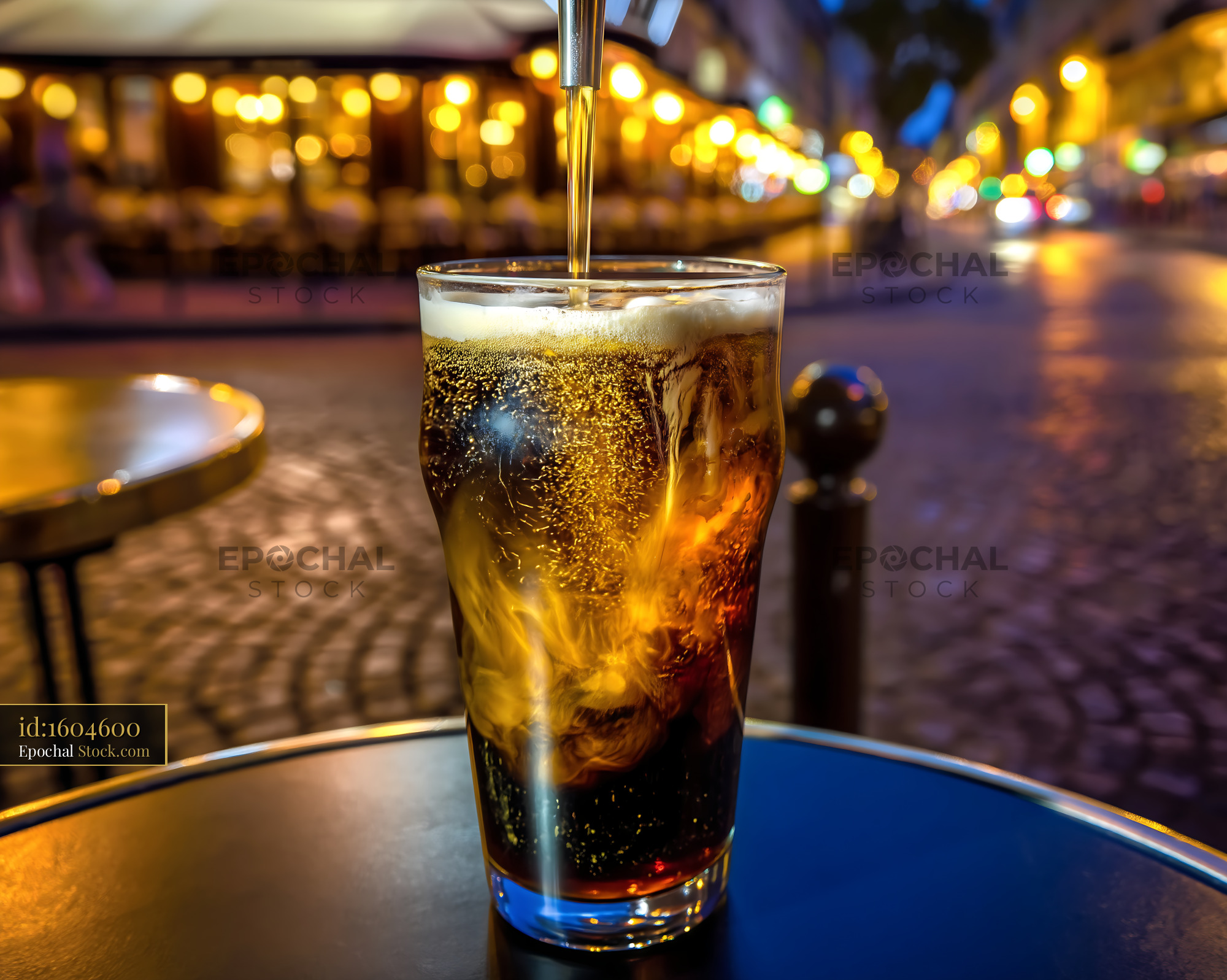 Refreshing Cola Poured into Icy Glass at Cafe - stock photo