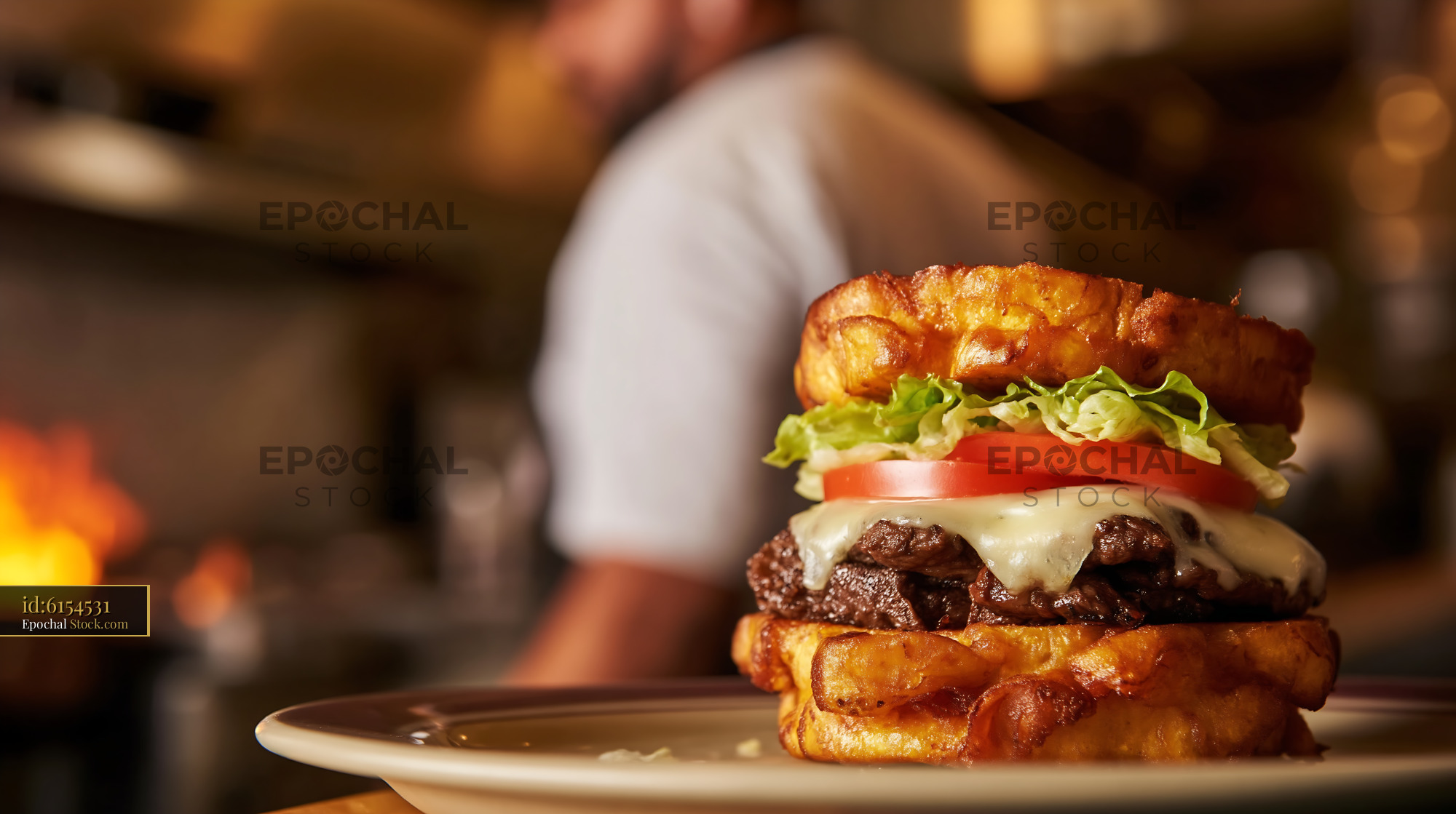 Gourmet Beef Burger on Croissant Bun in Restaurant - stock photo