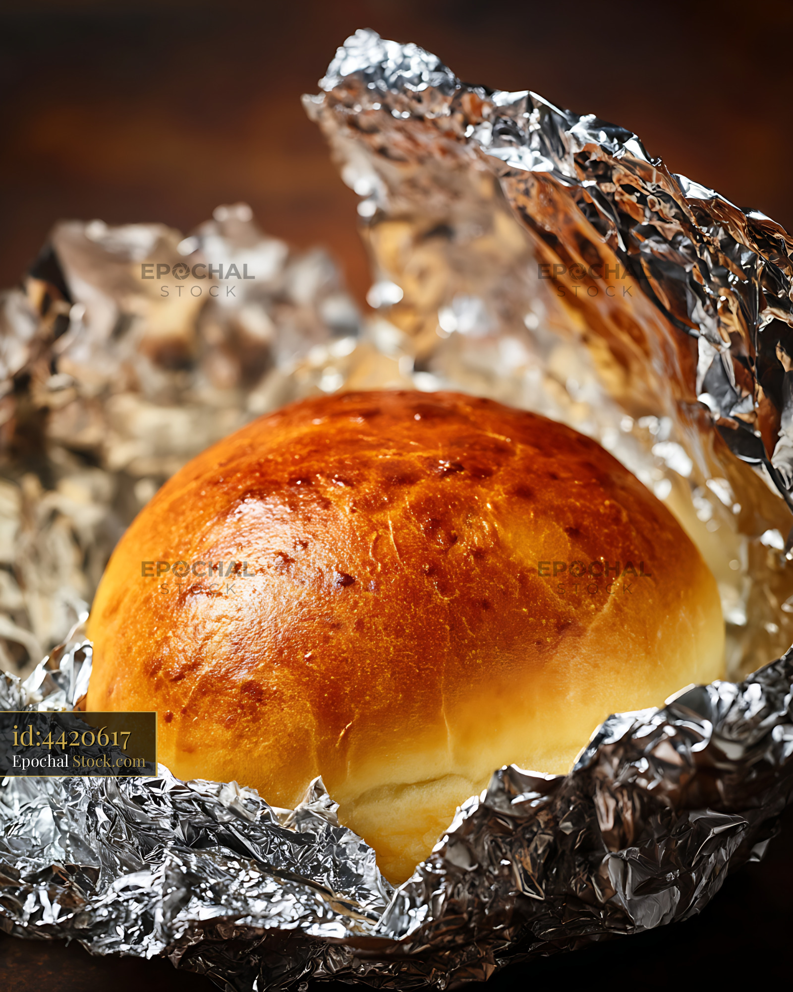 Fresh Golden Bread Roll in Aluminum Foil - stock photo