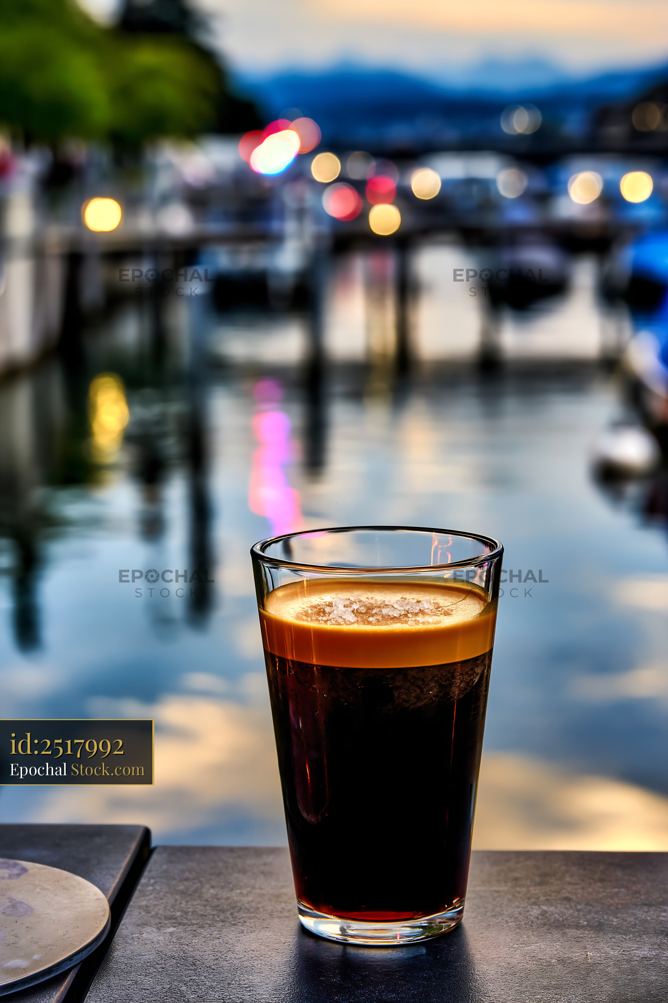 Refreshing Drink at Waterfront Sunset - stock photo