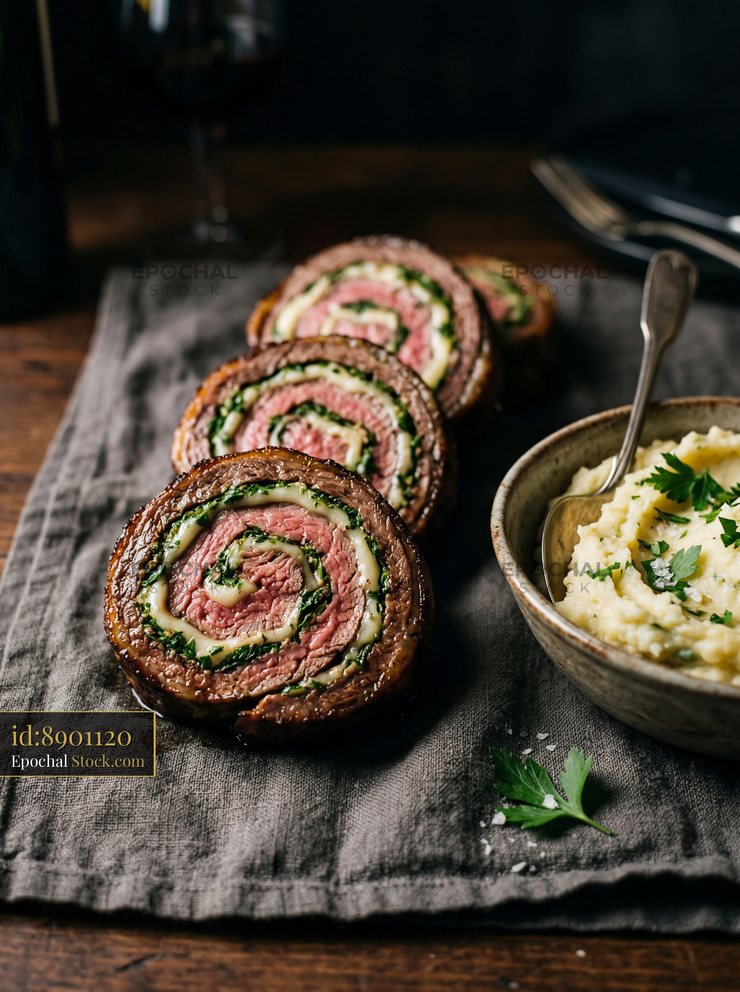 Herb-Crusted Beef Roulade with Creamy Potatoes - stock photo
