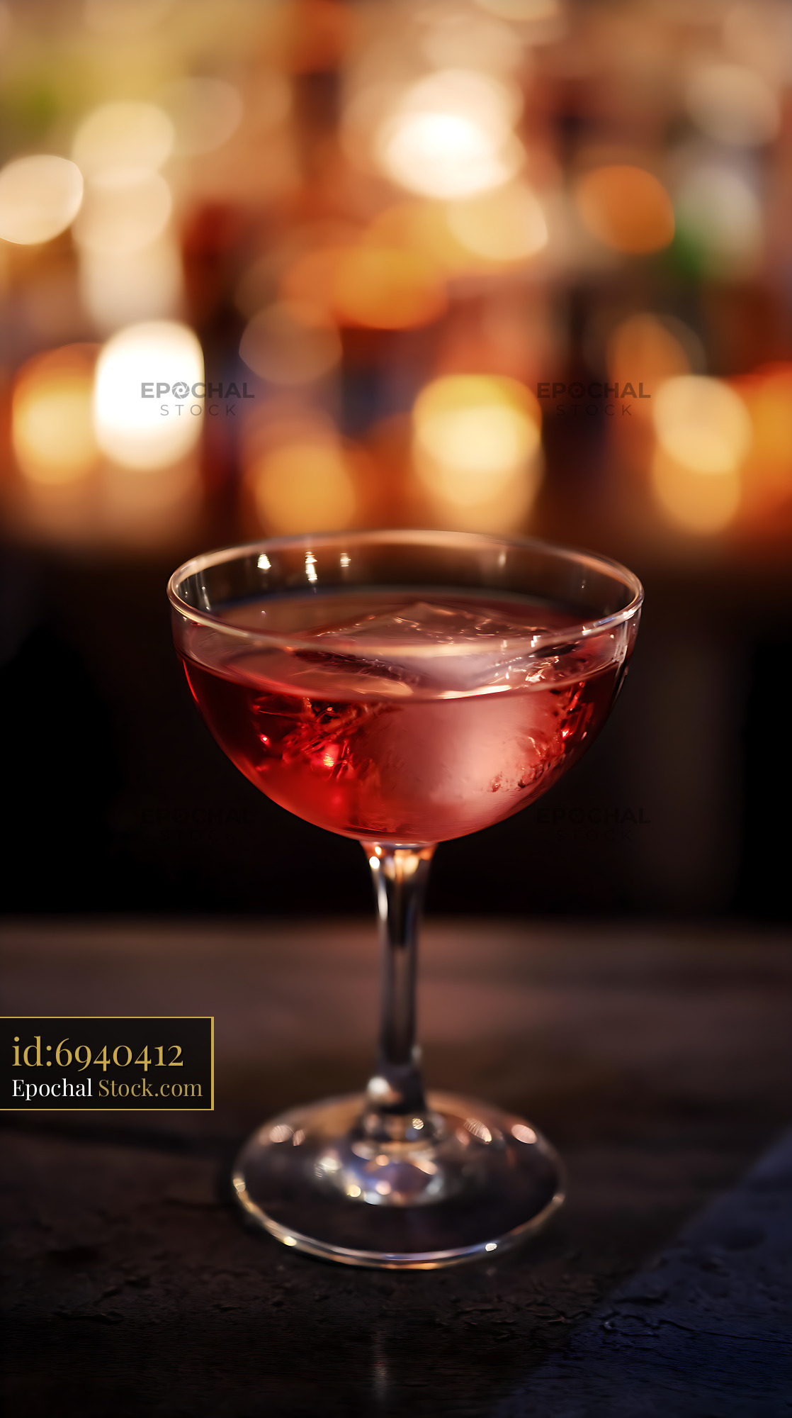 Red Cocktail with Ice and Warm Bokeh Lights - stock photo