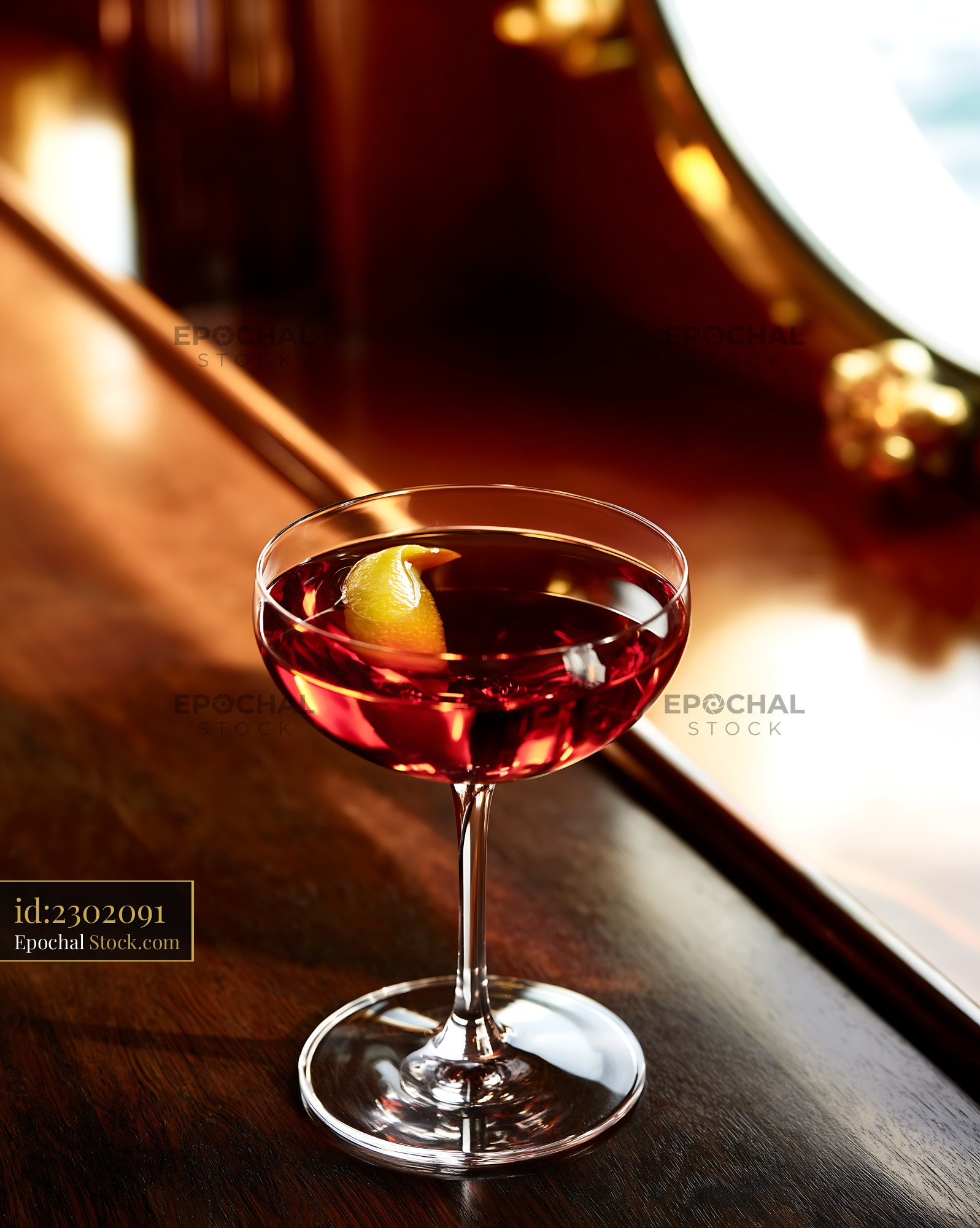 Red Cocktail with Lemon Twist in Coupe Glass - stock photo