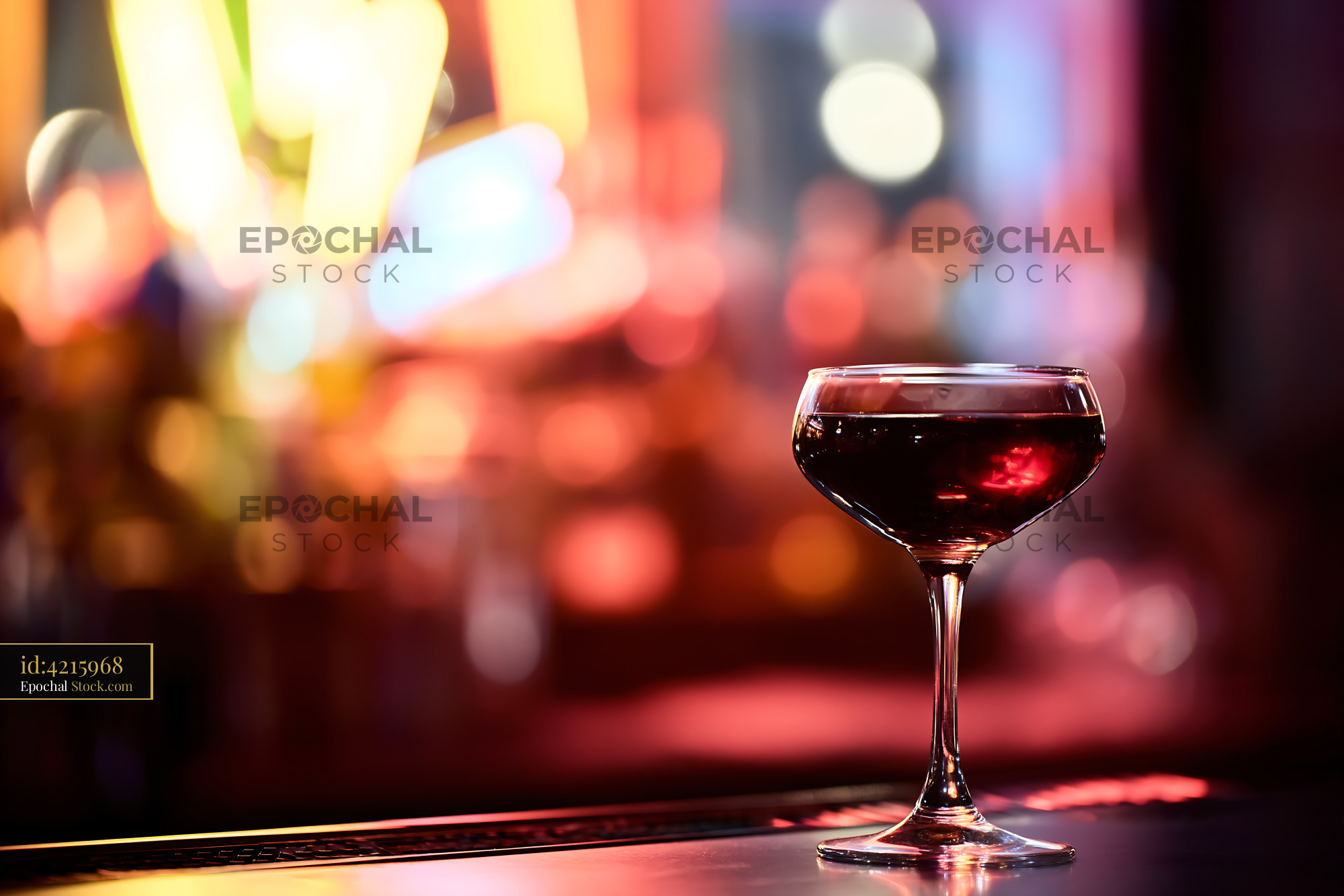Red Wine Coupe Glass with Bokeh Bar Lights - stock photo