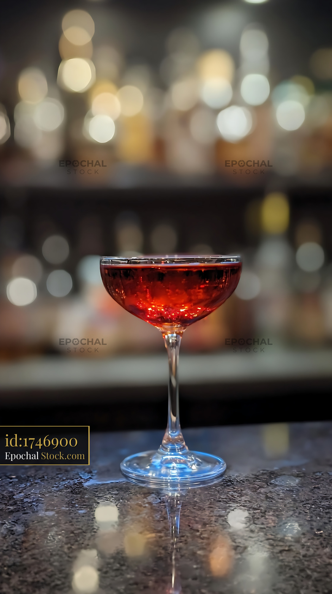 Bushwick Cocktail Glowing on Dark Bar Counter - stock photo