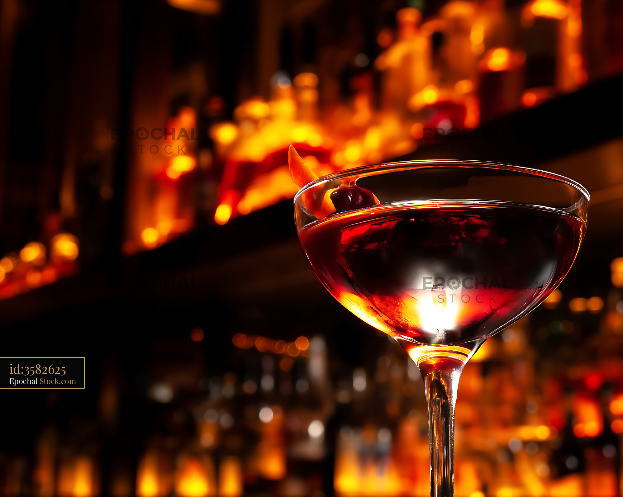 Bushwick Cocktail with Cherry Garnish by Firelight - stock photo