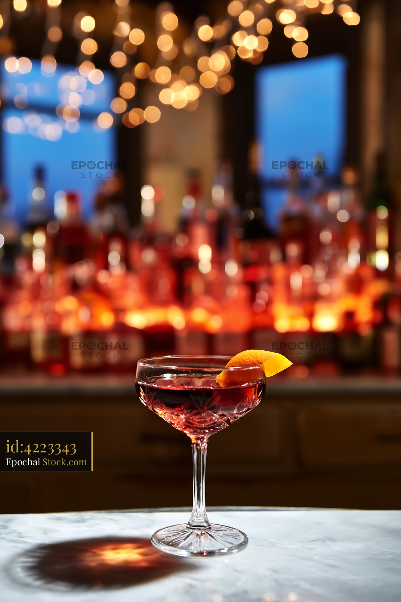 Red Cocktail with Lemon Twist Upscale Bar - stock photo