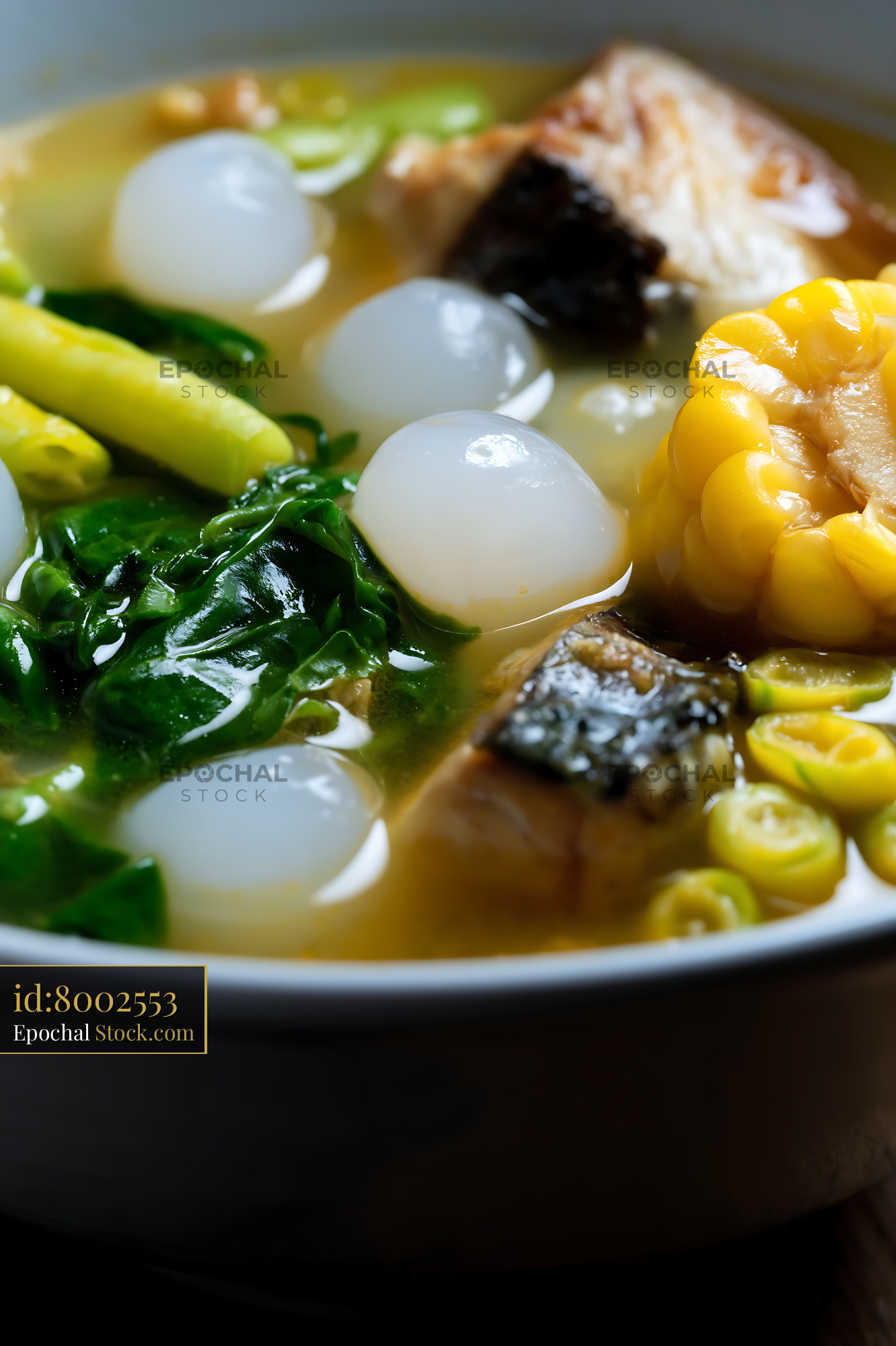Hearty Lor Mee Soup with Fish, Corn, and Greens - stock photo