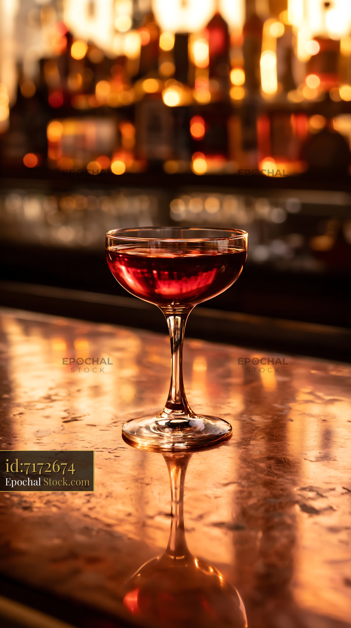 Red Cocktail on Bar Counter with Warm Bokeh - stock photo
