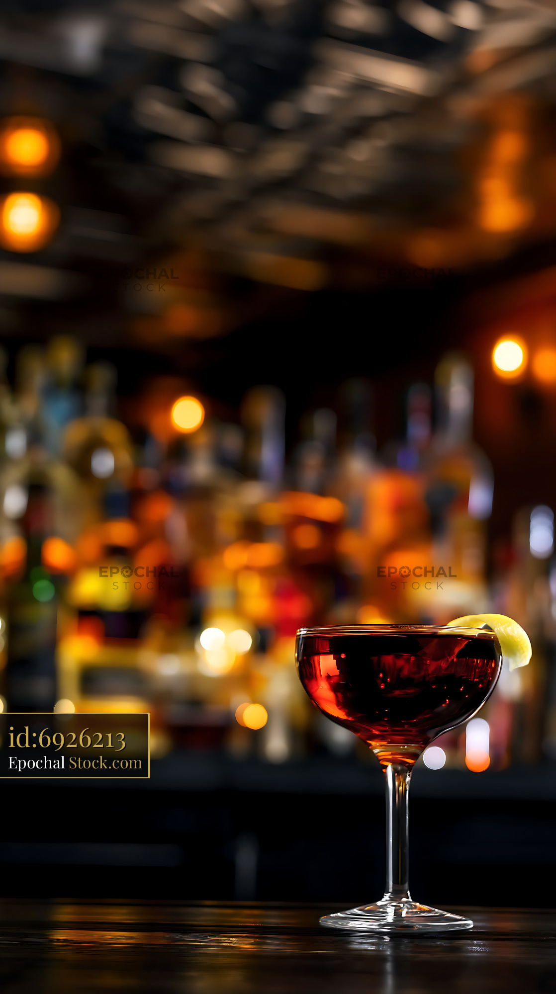 Elegant Red Cocktail with Lemon Garnish at Dim Bar - stock photo