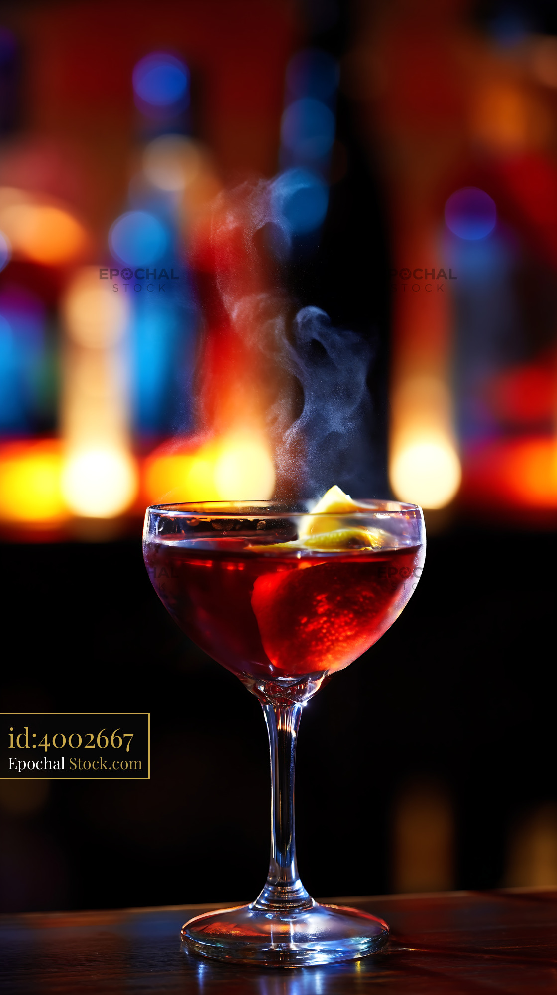 Steaming Red Cocktail with Lemon Garnish at Bar - stock photo