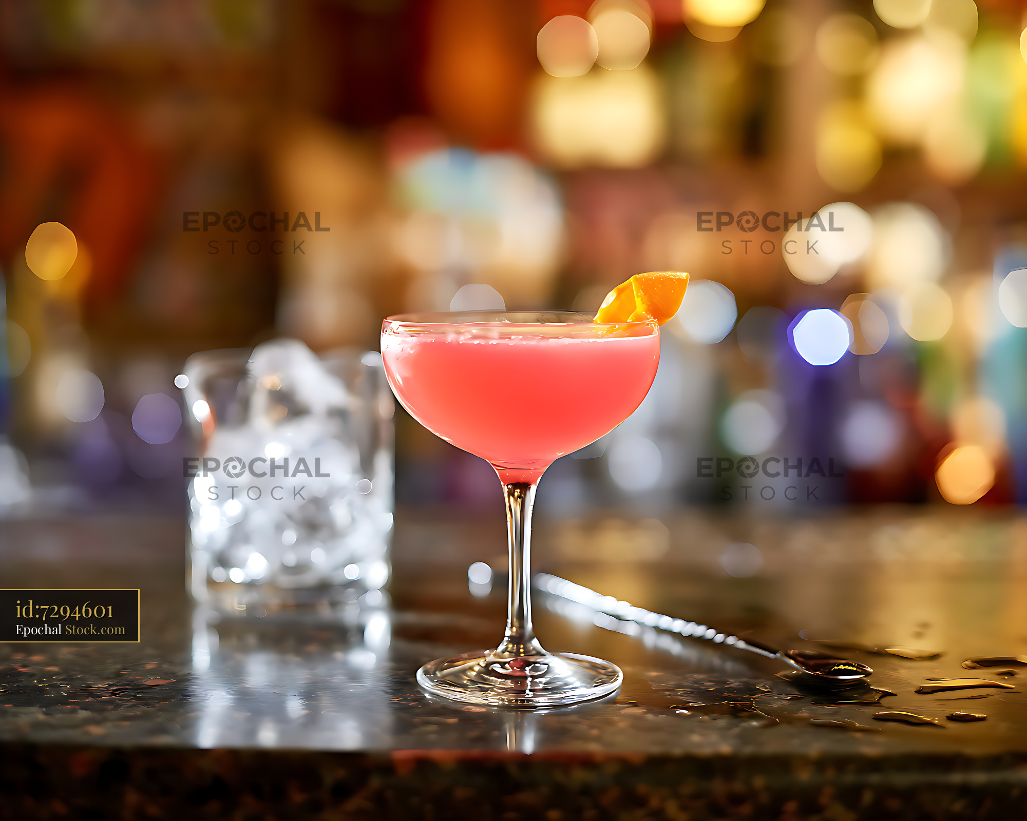 Vibrant Pink Cocktail in Coupe Glass on Bar at Night - stock photo