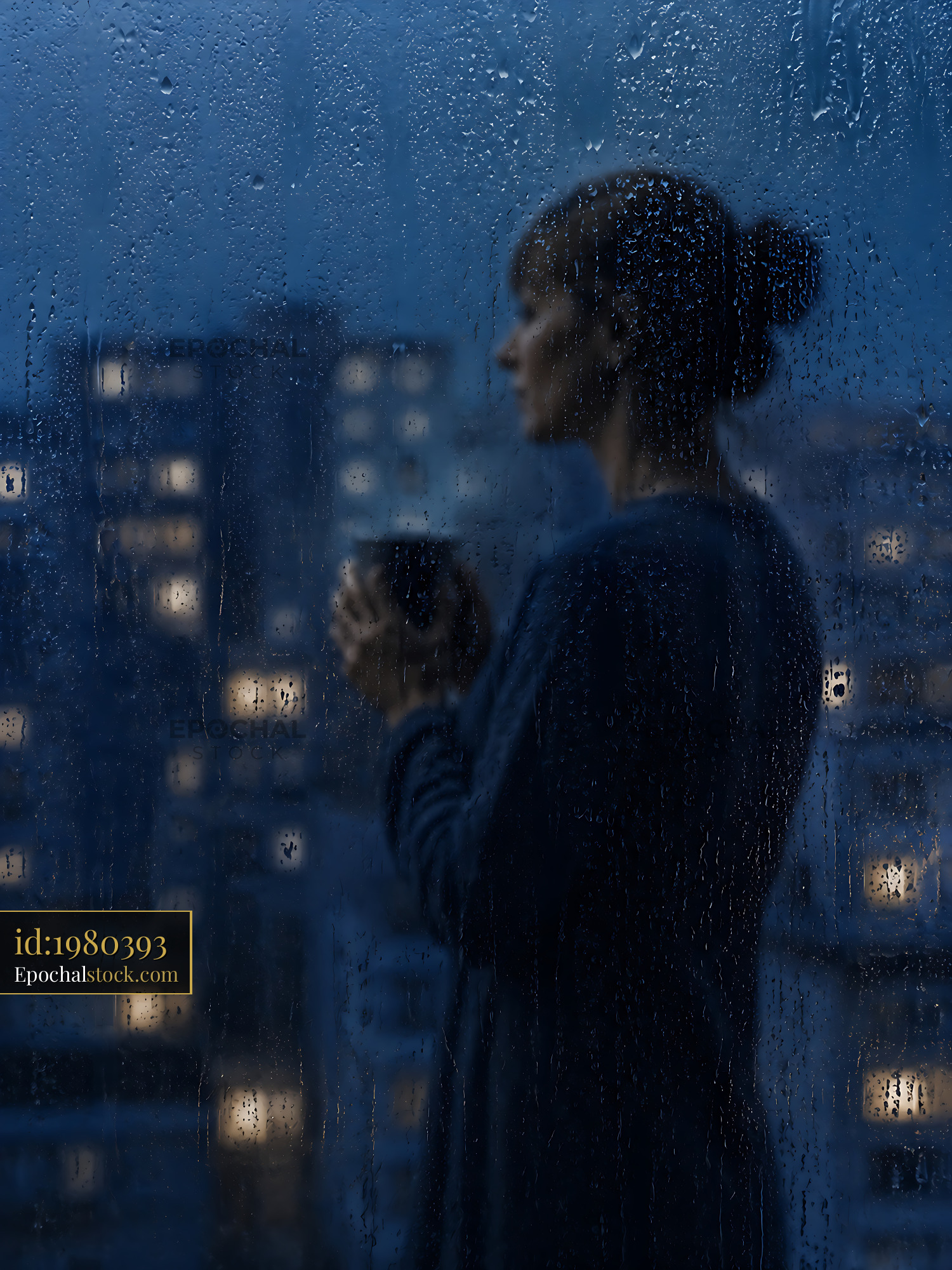 Watermarked full-resolution preview of Person holding cup while looking out rainy window at night