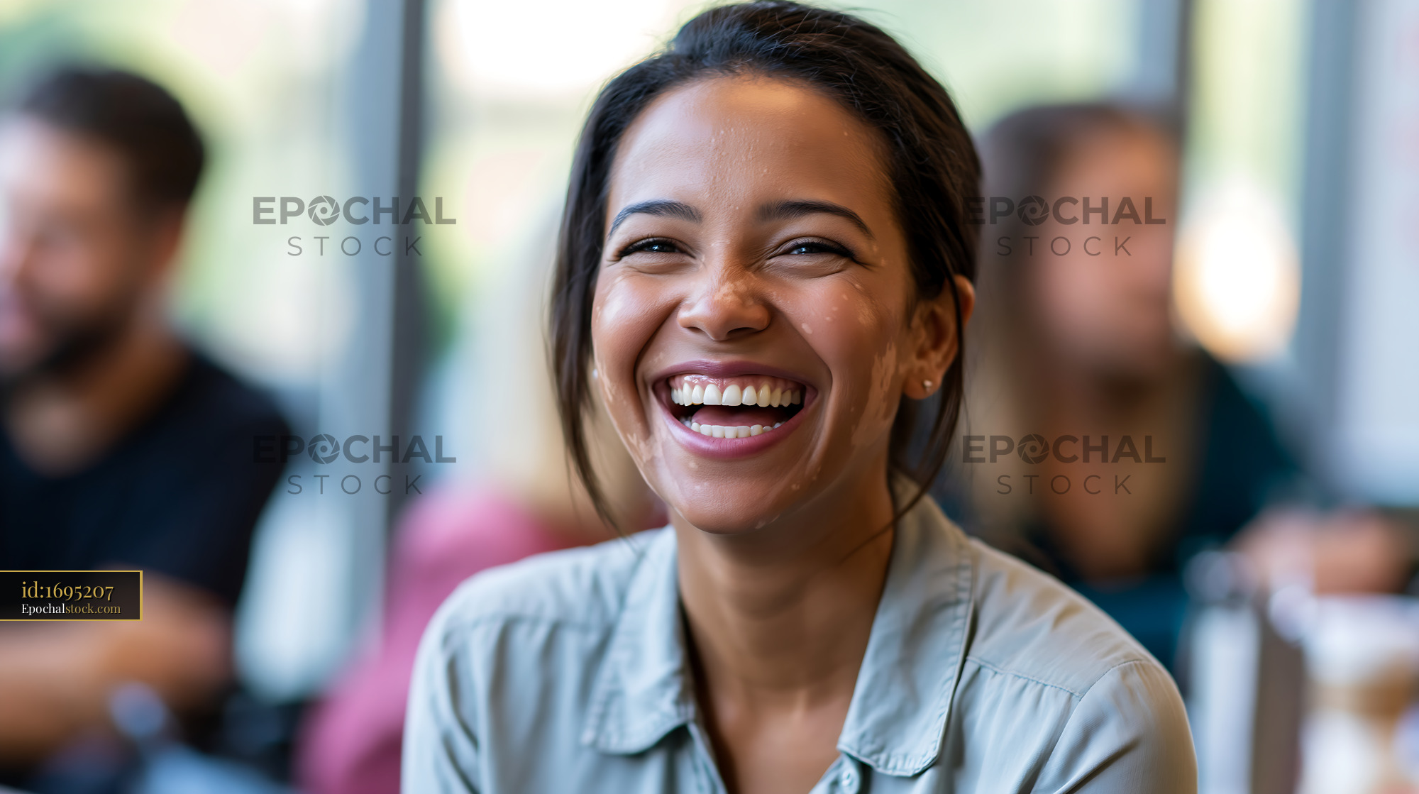 Watermarked full-resolution preview of Woman smiling in a cafe with people in the background