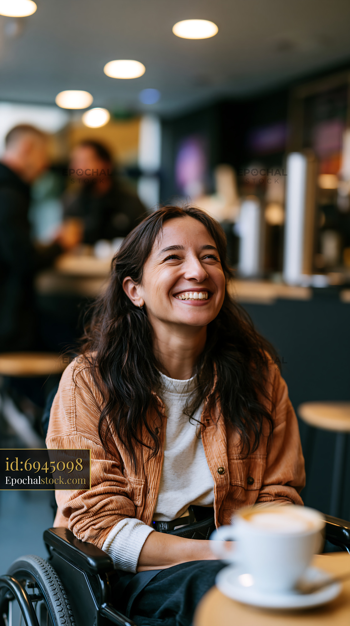 Watermarked full-resolution preview of Woman smiling in a cafe while seated in a wheelchair