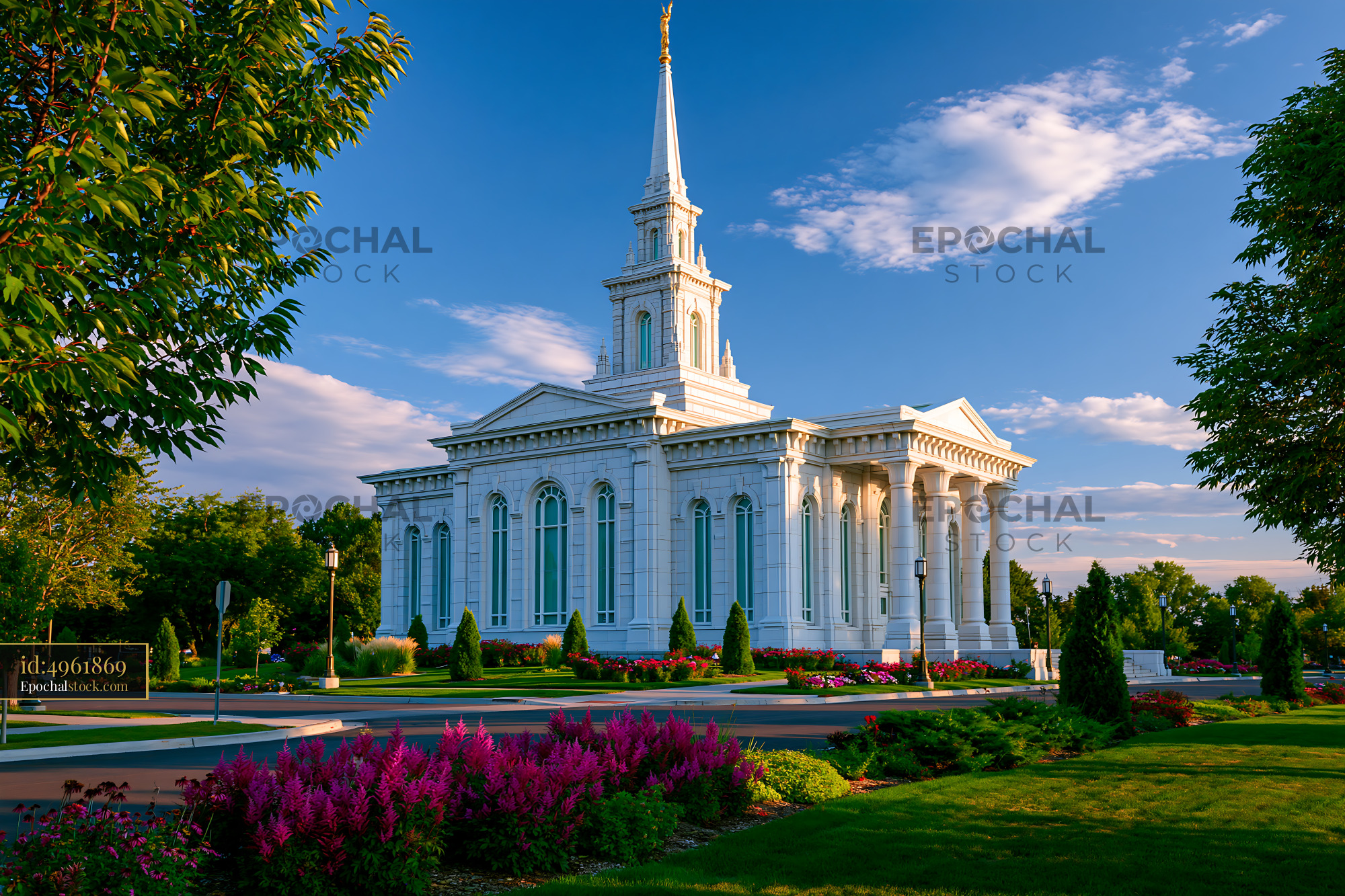 Watermarked full-resolution preview of Building with a spire surrounded by garden and blue sky