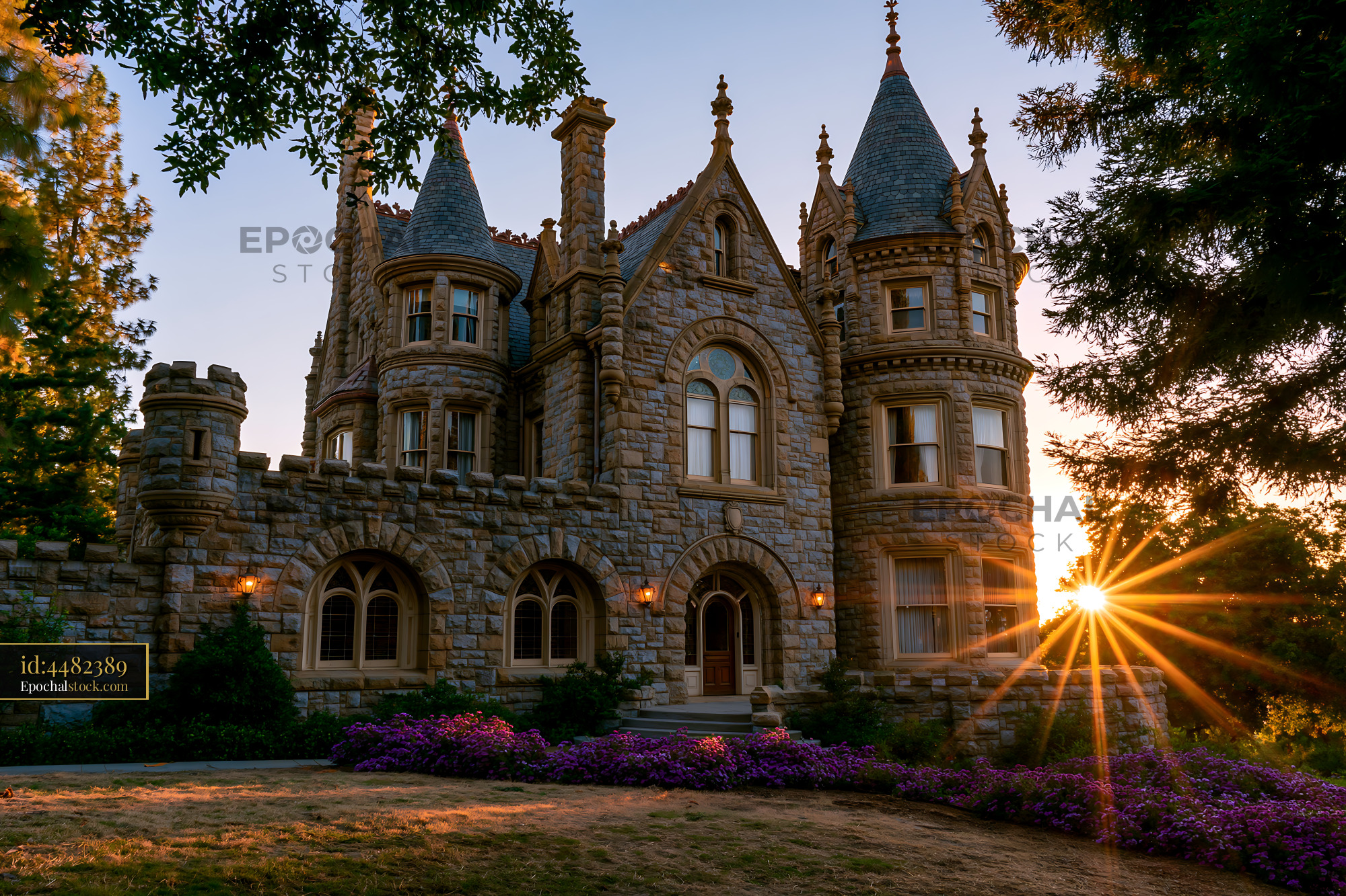 Watermarked full-resolution preview of Sunset view of a historic stone mansion with towers and gardens