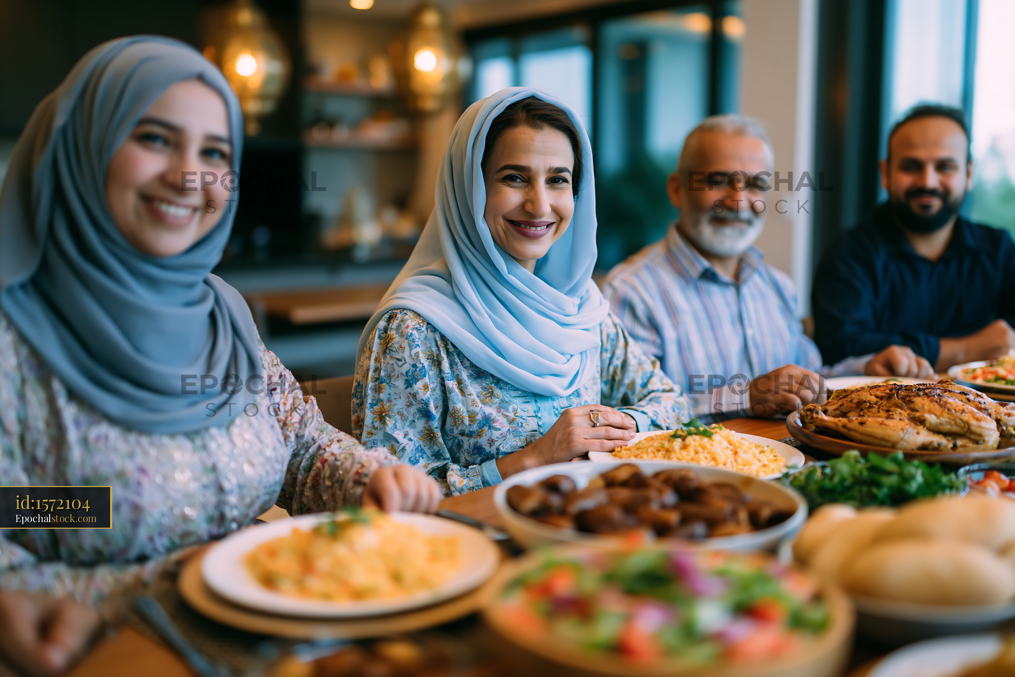 Family Sharing Iftar Dinner at Home During Ramadan - stock photo