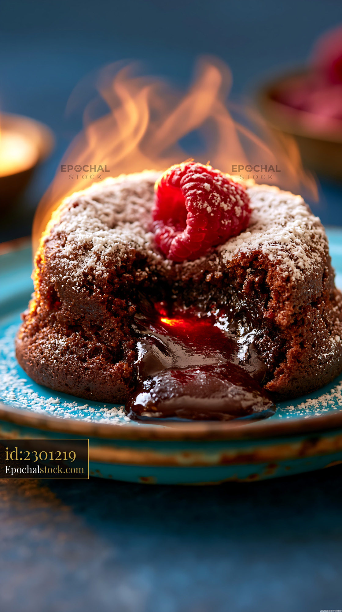 Watermarked full-resolution preview of Chocolate lava cake with raspberries on a blue plate
